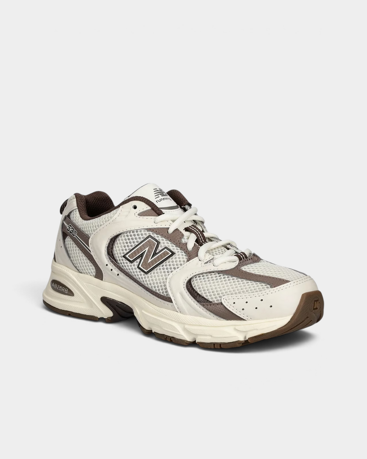New Balance 530 in turtledove and mushroom, three-quarter front view of the mesh toe and sweeping synthetic overlays