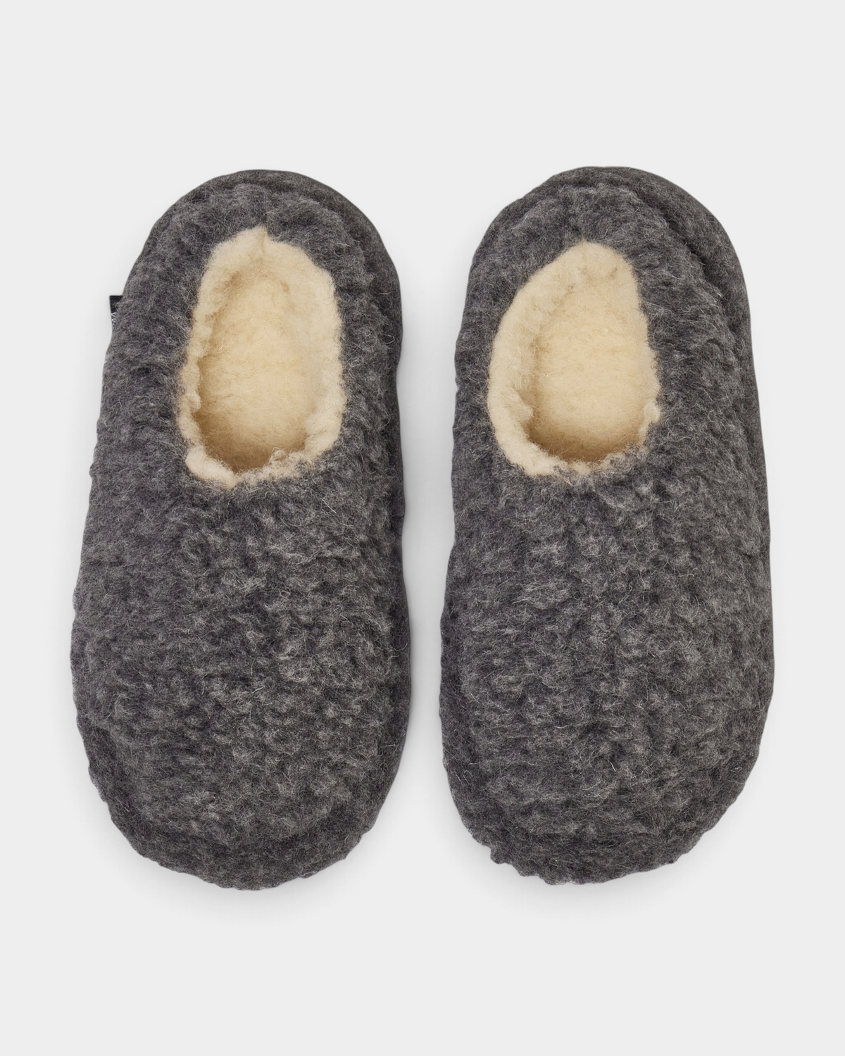 A pair of Rue De Wool The Nordic Low slippers in iron grey, top view showing the natural wool lining