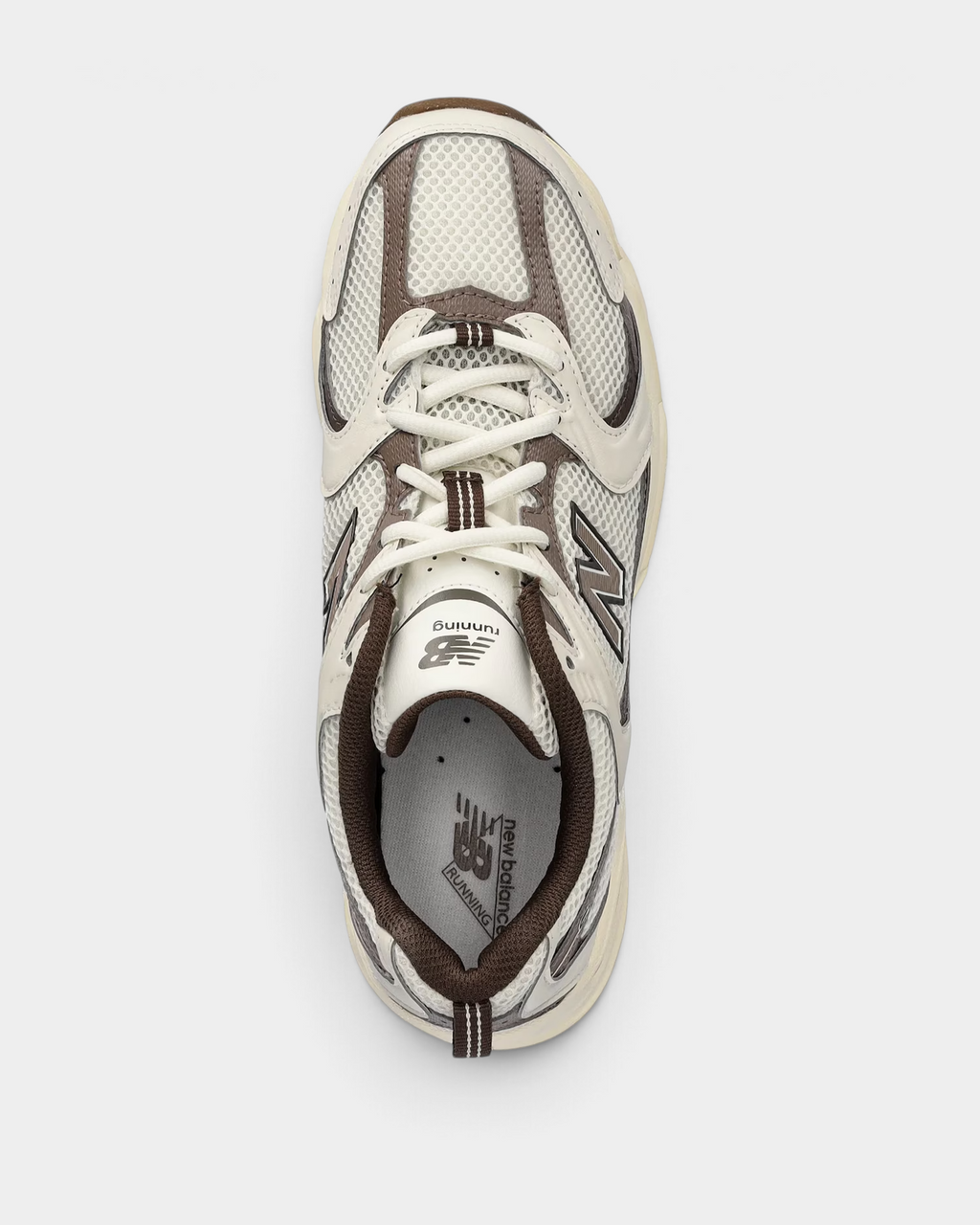 Top-down view of the New Balance 530 in turtledove and angora, showing the off-white laces and mushroom brown tongue trim