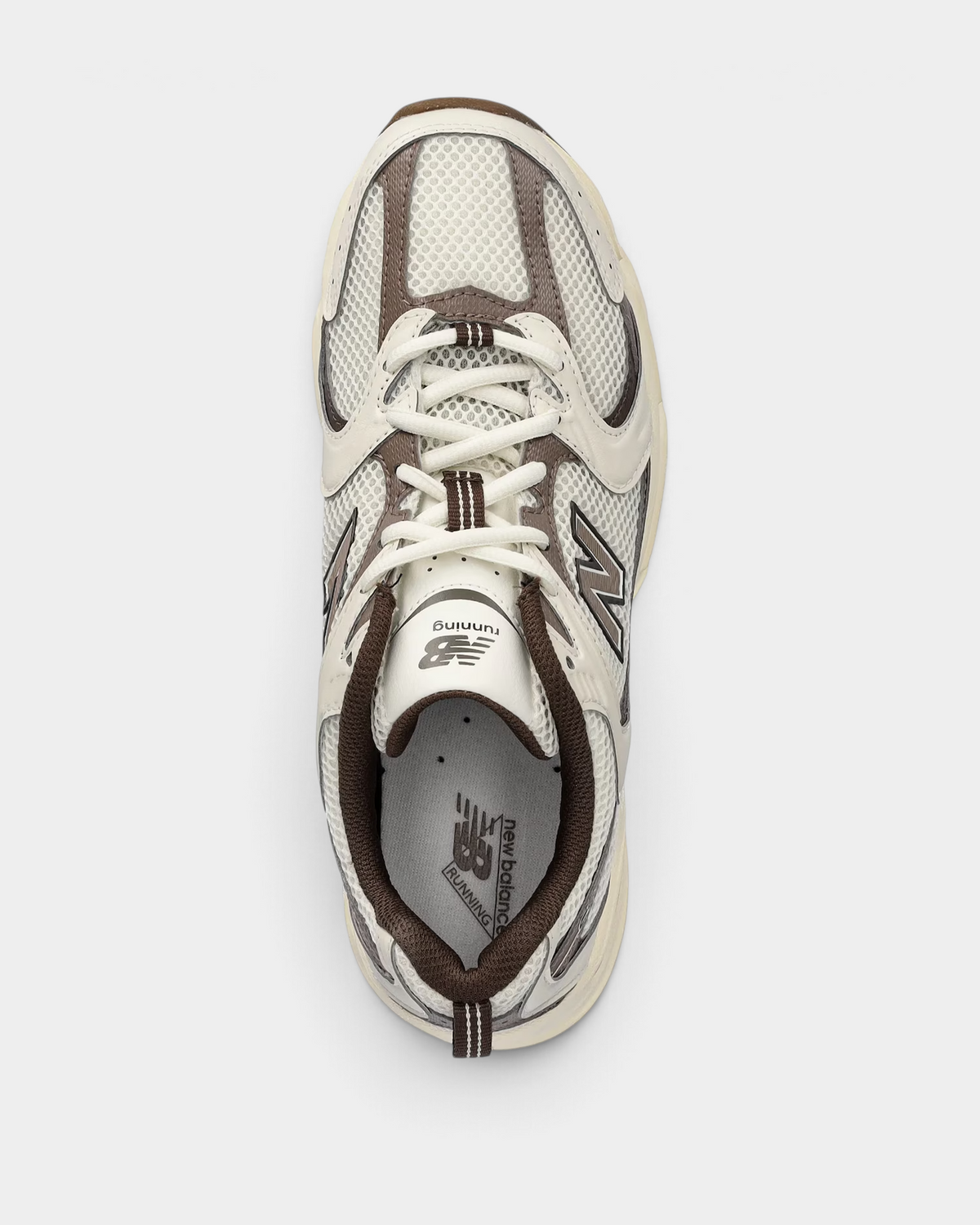 Top-down view of the New Balance 530 in turtledove and angora, showing the off-white laces and mushroom brown tongue trim