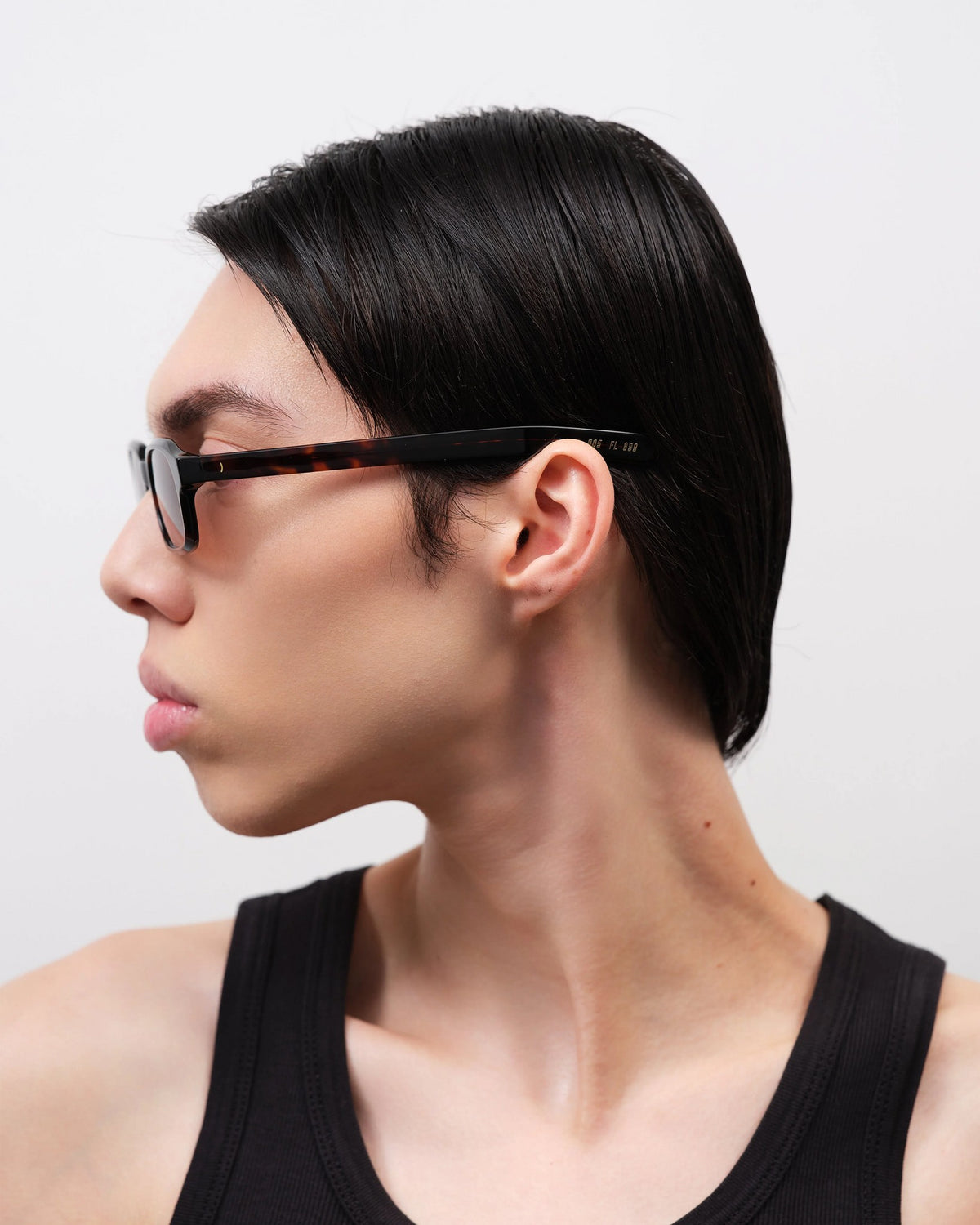 Side profile of a man wearing the Flatlist Hanky sunglasses, showing the slim dark tortoise acetate temple