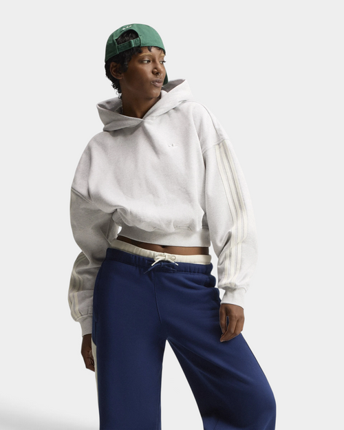 Lockwood Avenue adidas adiSignature 3-Stripes Hoodie in light grey heather on a model with a green cap and navy sweatpants, front view with the hood down