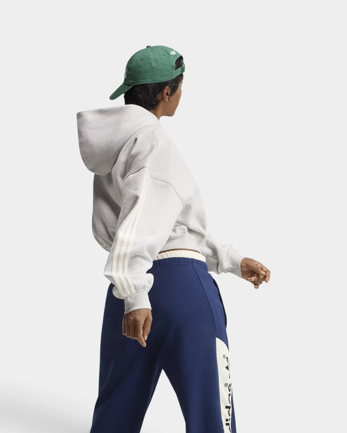 Lockwood Avenue adidas adiSignature 3-Stripes Hoodie in light grey heather, side view of the sleeve stripes and hood on a model with a green cap