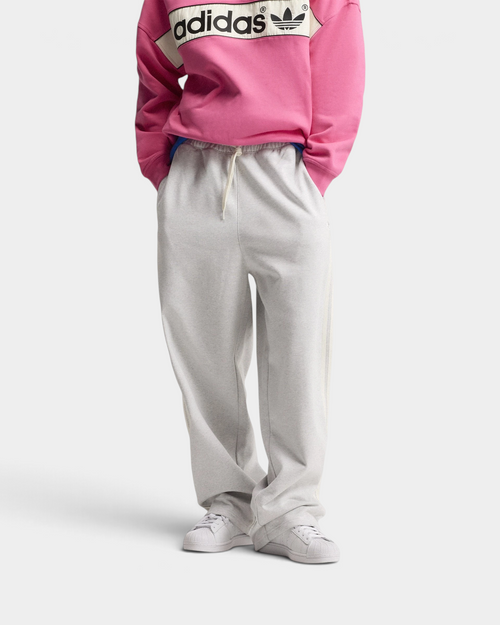 Lockwood Avenue adidas adiSignature 3-Stripes Open Hem Sweatpants in light grey heather, front view from the chest down with a pink adidas sweatshirt, hands in the pockets