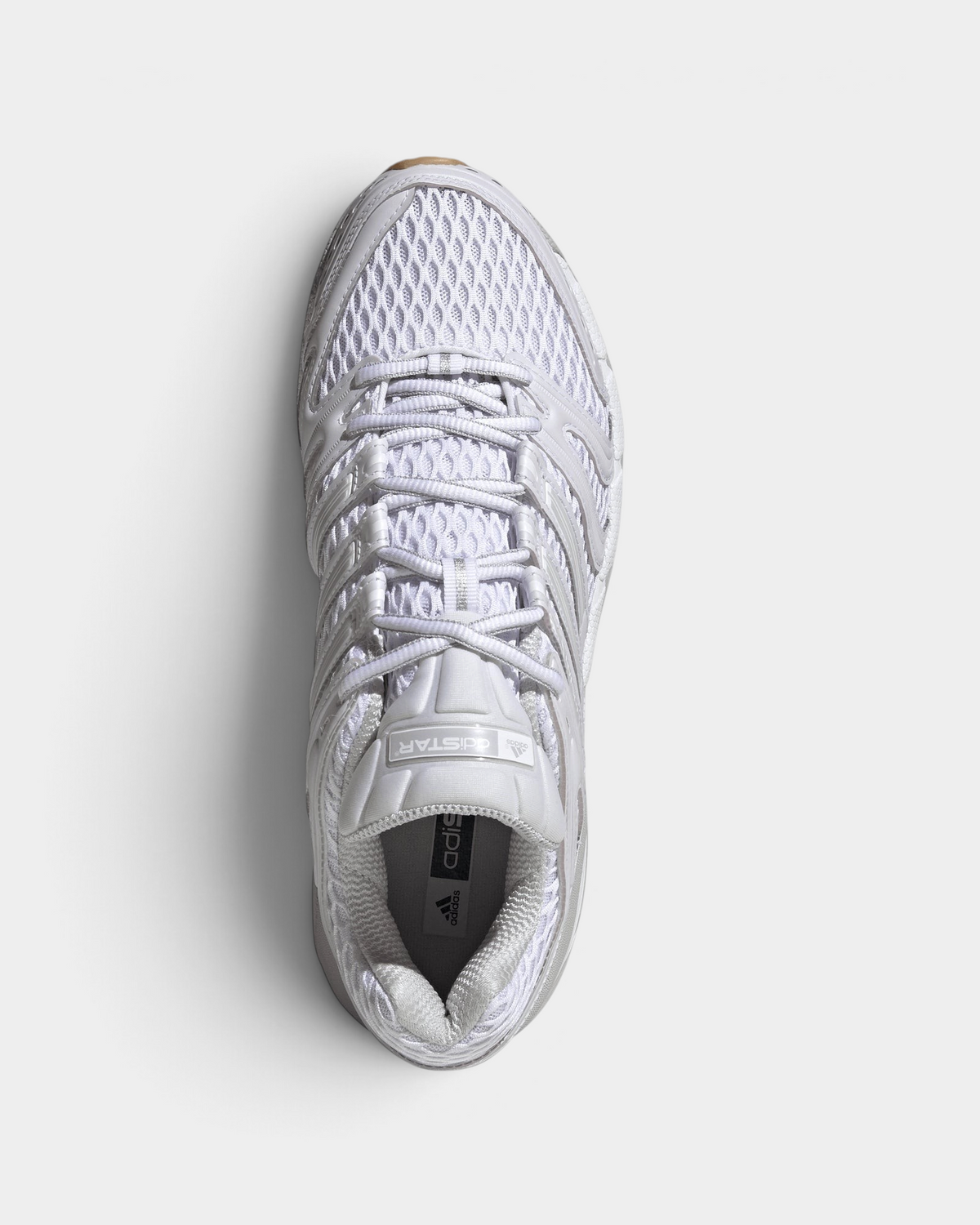 Lockwood Avenue adidas Adistar Control 5 shoe in white with pale grey overlays and a gum sole, seen from above with the open mesh upper, the laces and the adidas logo on the insole