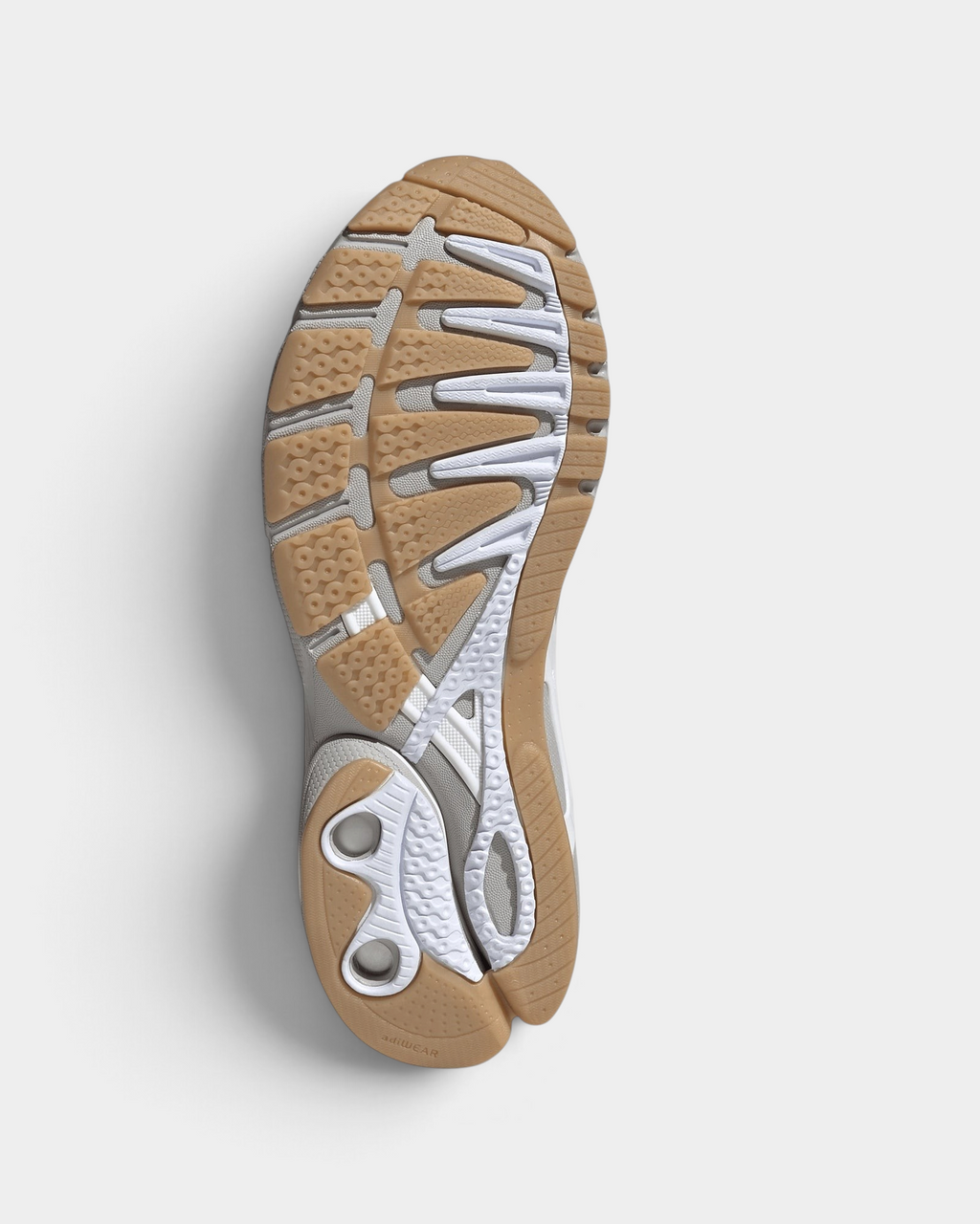 Lockwood Avenue adidas Adistar Control 5 shoe in white with pale grey overlays and a gum sole, turned over to show the gum rubber outsole and the cut-outs in the grey midsole