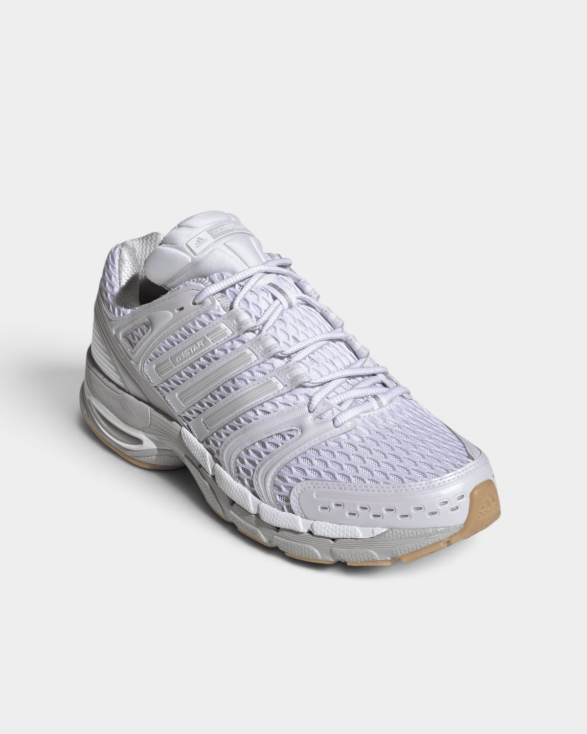 Lockwood Avenue adidas Adistar Control 5 shoe in white with pale grey overlays and a gum sole, angled front view of the open mesh upper and the laces