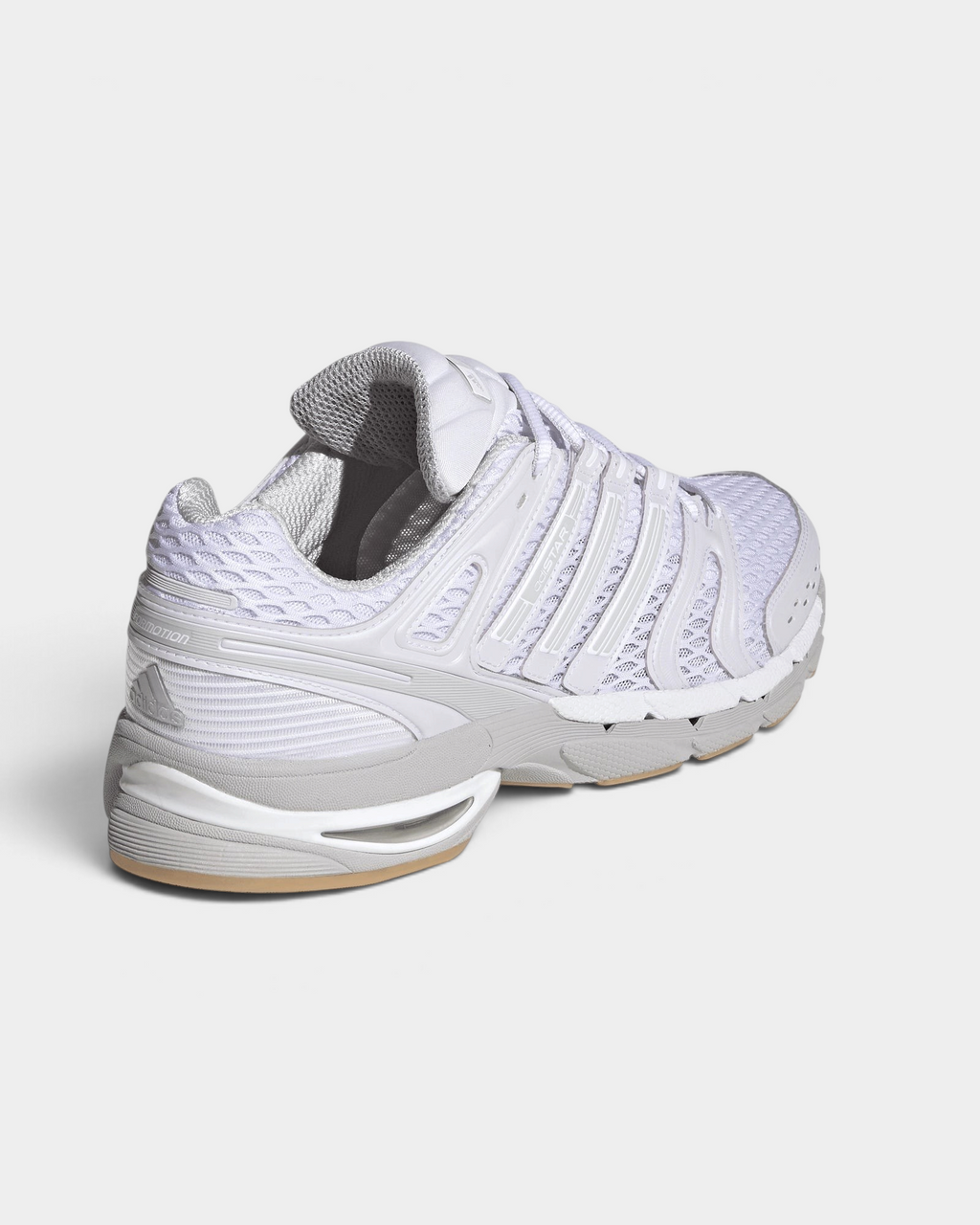 Lockwood Avenue adidas Adistar Control 5 shoe in white with pale grey overlays and a gum sole, seen from behind at an angle, the heel and the gum sole