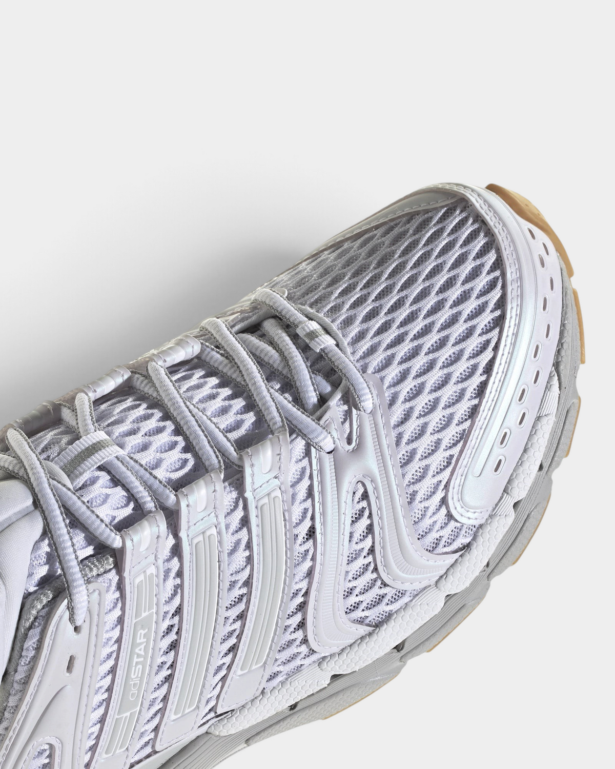 Lockwood Avenue adidas Adistar Control 5 shoe in white with pale grey overlays and a gum sole, close up of the laces and the open mesh toe