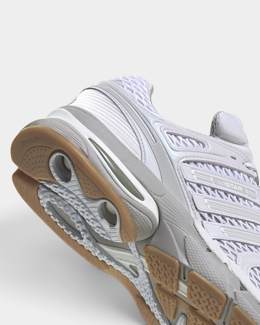 Lockwood Avenue adidas Adistar Control 5 shoe in white with pale grey overlays and a gum sole, close up of the heel, the midsole cut-outs and the gum outsole