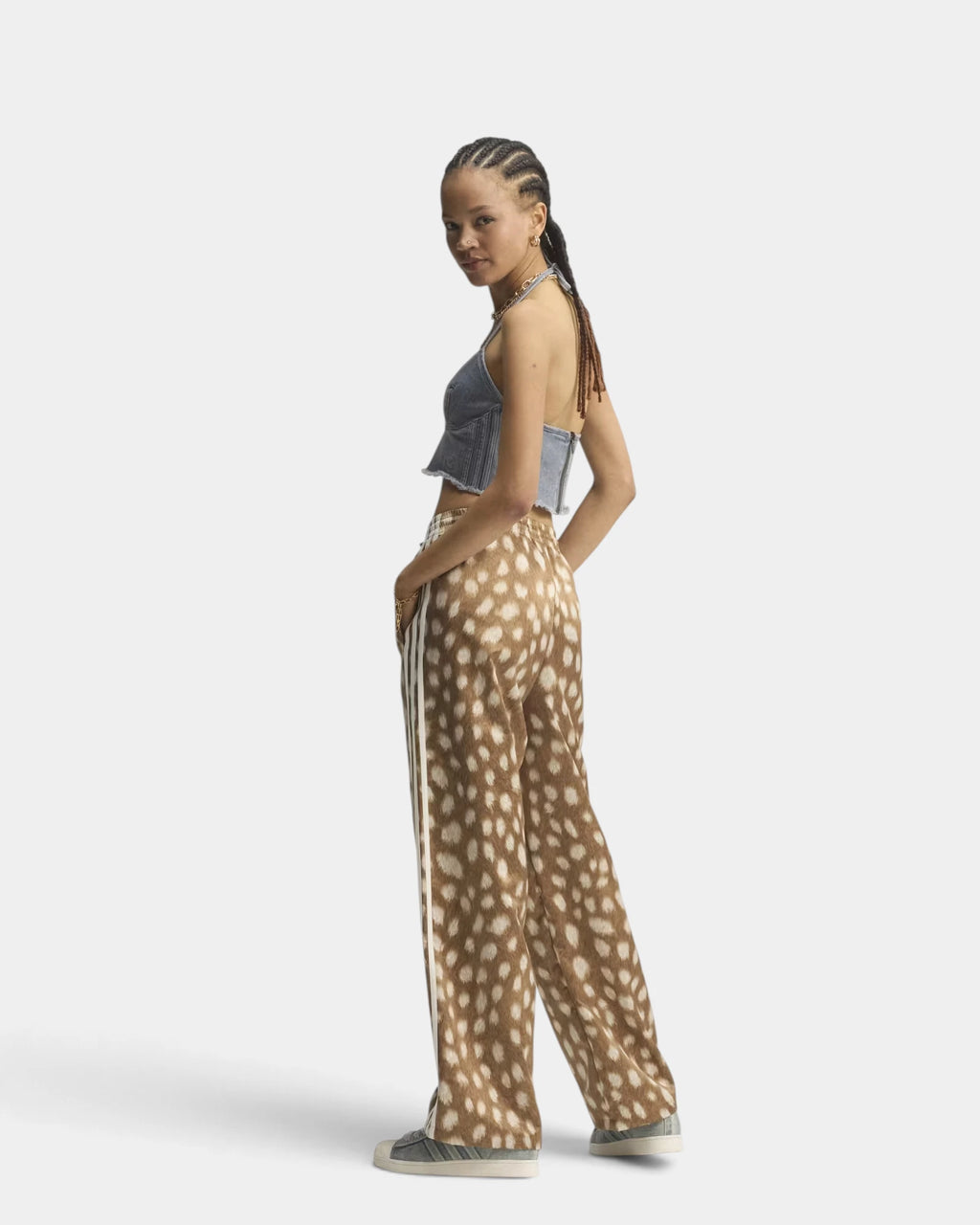 Lockwood Avenue adidas Firebird Animal Print Track Pants worn by a model seen from the side and behind, the wide leg falling over grey sneakers