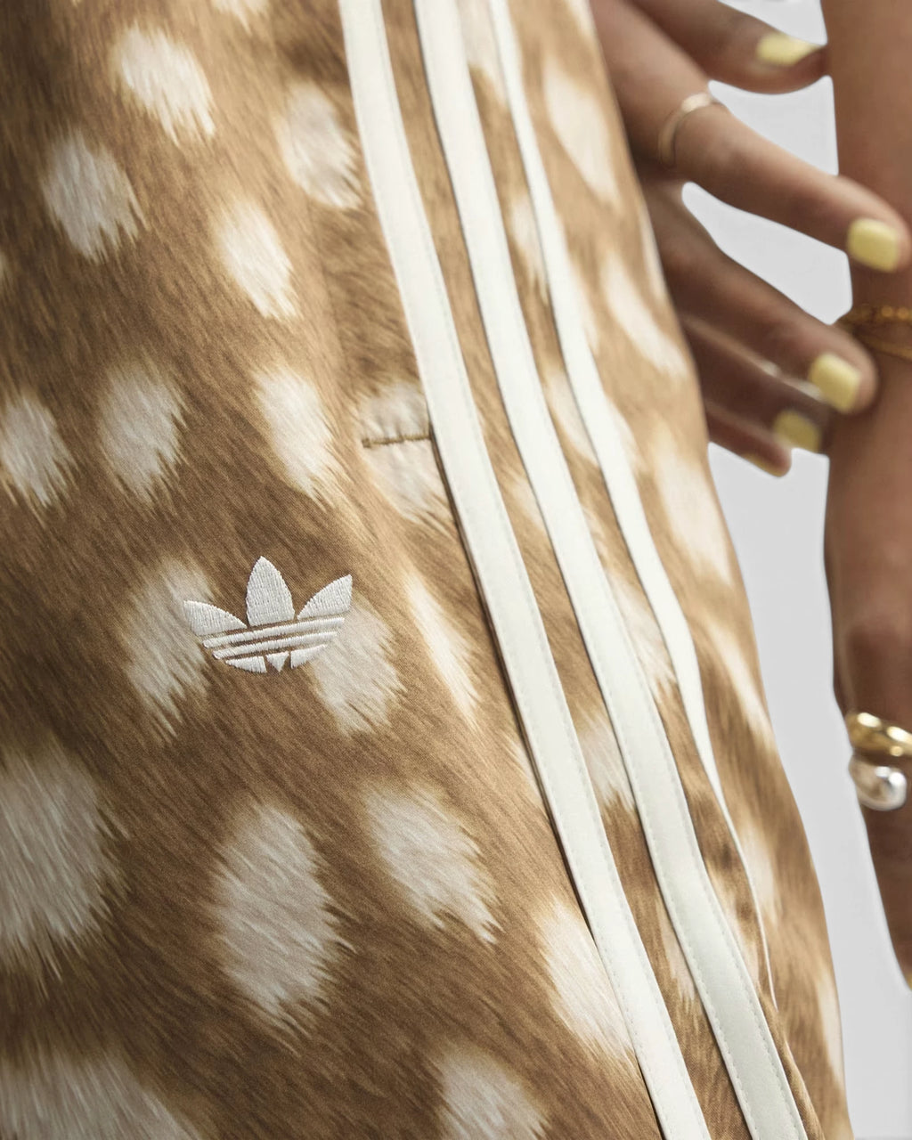 Lockwood Avenue adidas Firebird Animal Print Track Pants close up, the fawn-spot print, cream 3-Stripes and embroidered Trefoil on the thigh