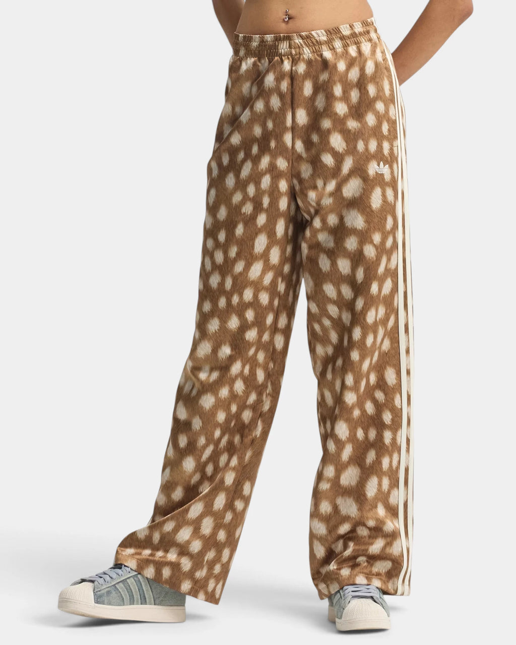 Lockwood Avenue adidas Firebird Animal Print Track Pants worn by a model from the waist down, the wide straight leg over grey sneakers