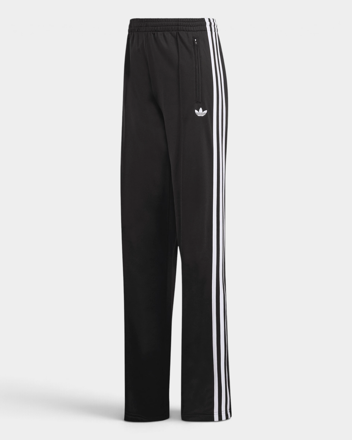 Lockwood Avenue adidas Firebird Loose Track Pants in black, flat front view with white 3-Stripes down the legs, a white Trefoil on the thigh and a zip pocket