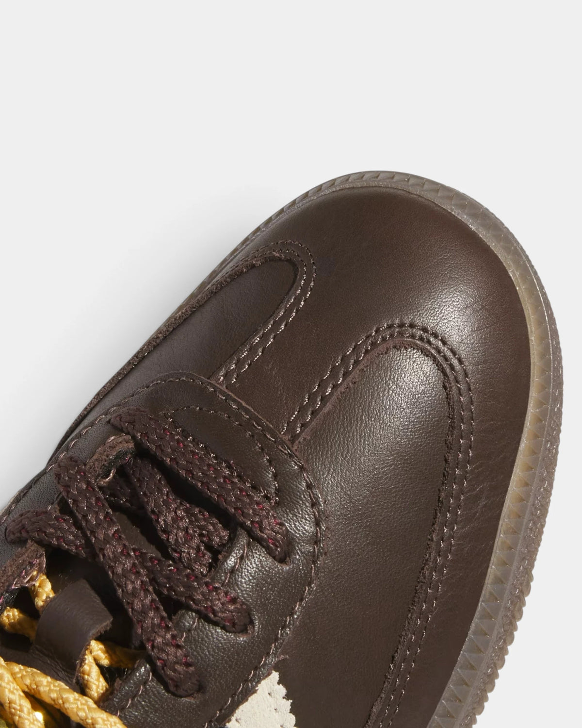 Lockwood Avenue adidas Samba OG W shoe close up, the gold laces and stitched brown leather toe