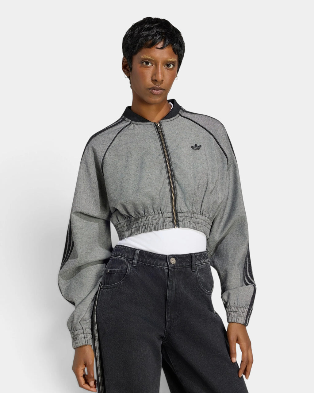 Lockwood Avenue adidas SST Denim Track Top in light grey denim, worn zipped with black jeans, front view showing the black Trefoil and cropped gathered hem