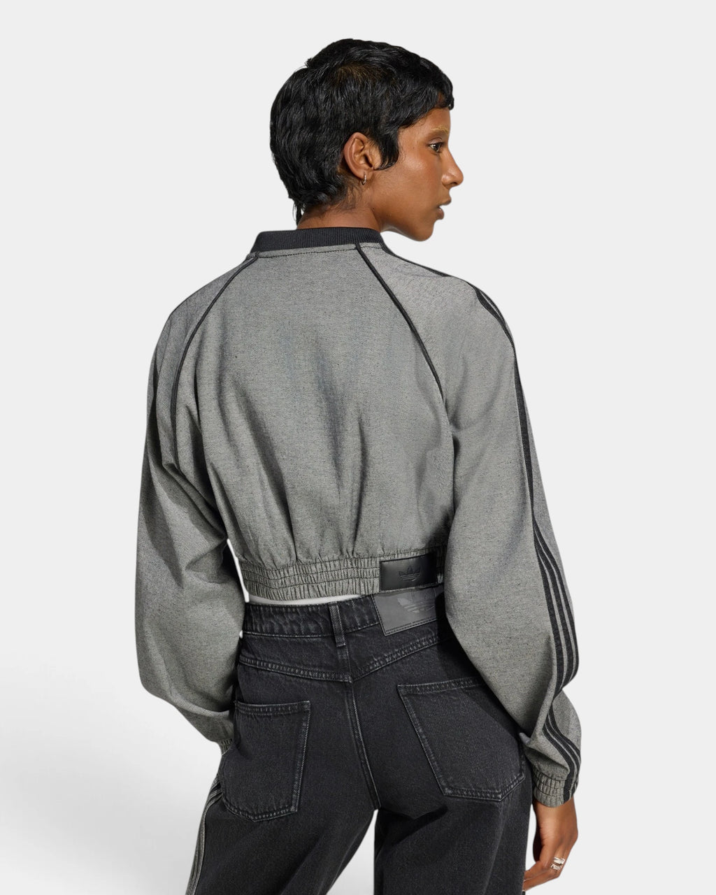 Lockwood Avenue adidas SST Denim Track Top in light grey denim seen from behind, black 3-Stripes down the sleeves and a cropped elastic hem