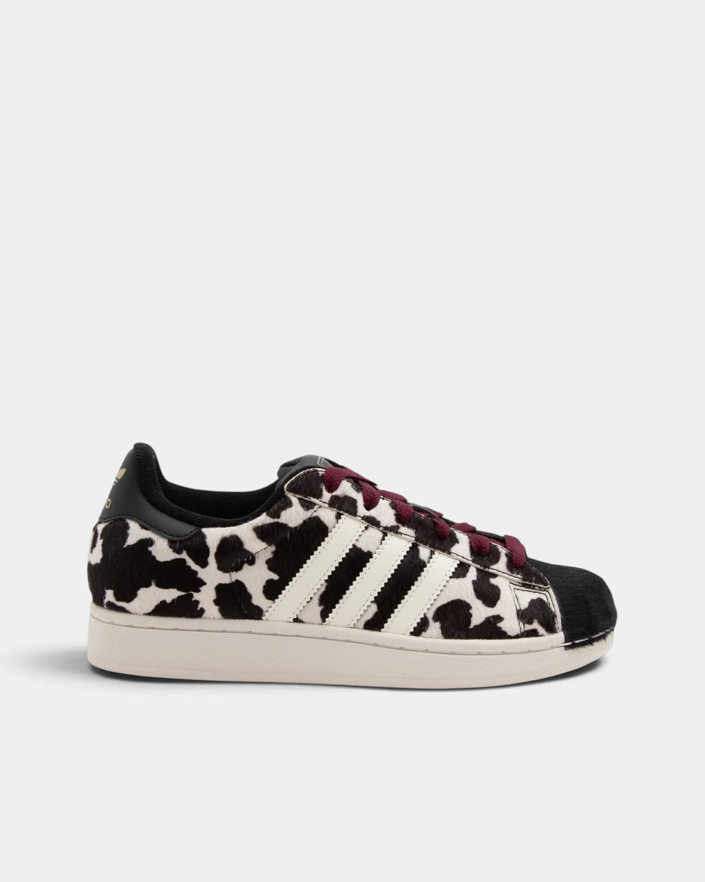 Lockwood Avenue adidas Superstar II W shoe in a black and off-white animal print, side view with the black shell toe, white 3-Stripes and maroon laces