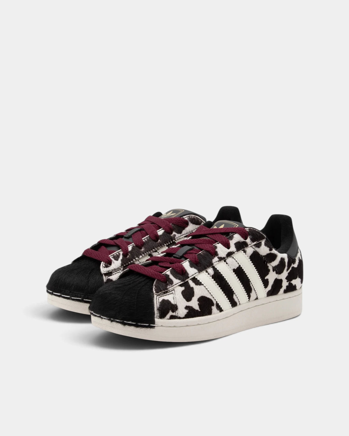 Lockwood Avenue adidas Superstar II W shoes in a black and off-white animal print, angled front view of the pair showing the shell toes and maroon laces