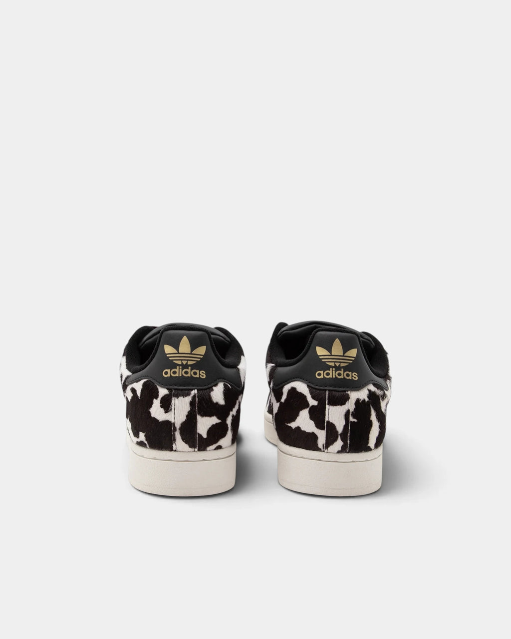 Lockwood Avenue adidas Superstar II W shoes in a black and off-white animal print, rear view of the pair with a gold Trefoil on each black heel tab
