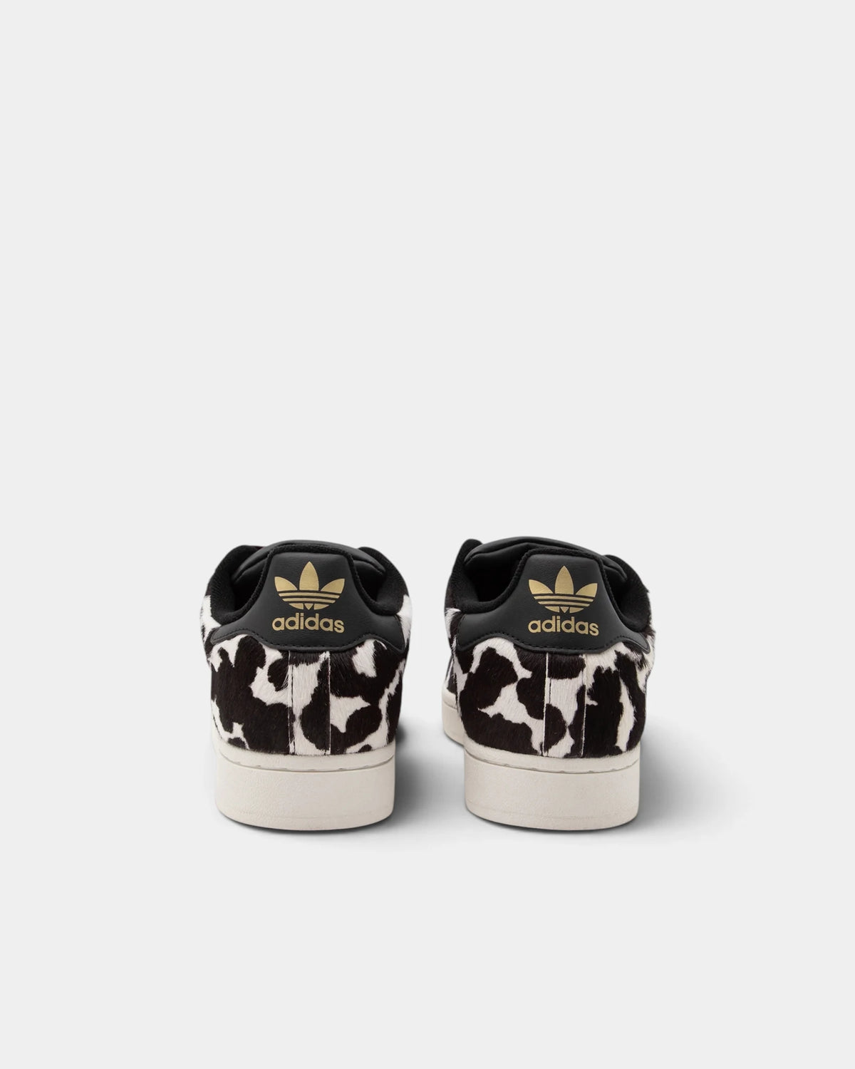 Lockwood Avenue adidas Superstar II W shoes in a black and off-white animal print, rear view of the pair with a gold Trefoil on each black heel tab