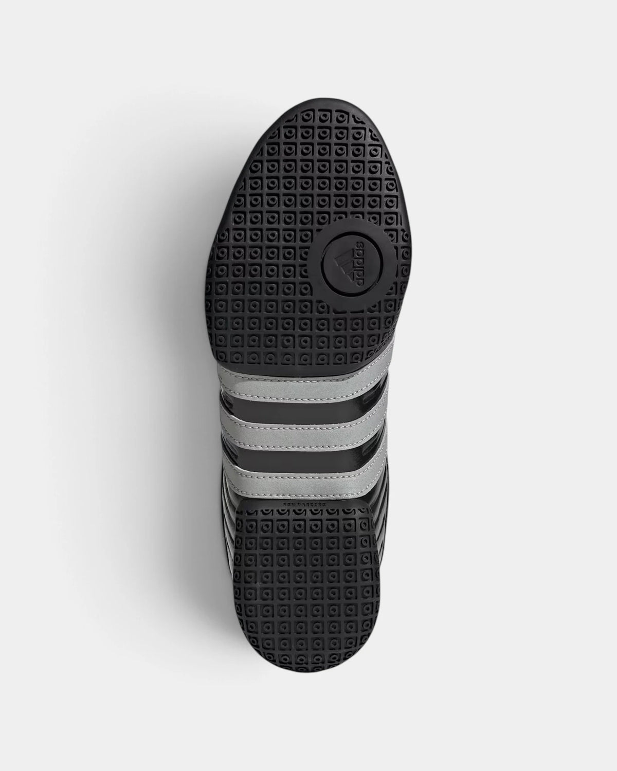 Lockwood Avenue adidas Taekwondo Mei Elite shoe turned over, showing the black pivot outsole with silver metallic 3-Stripes across the midfoot