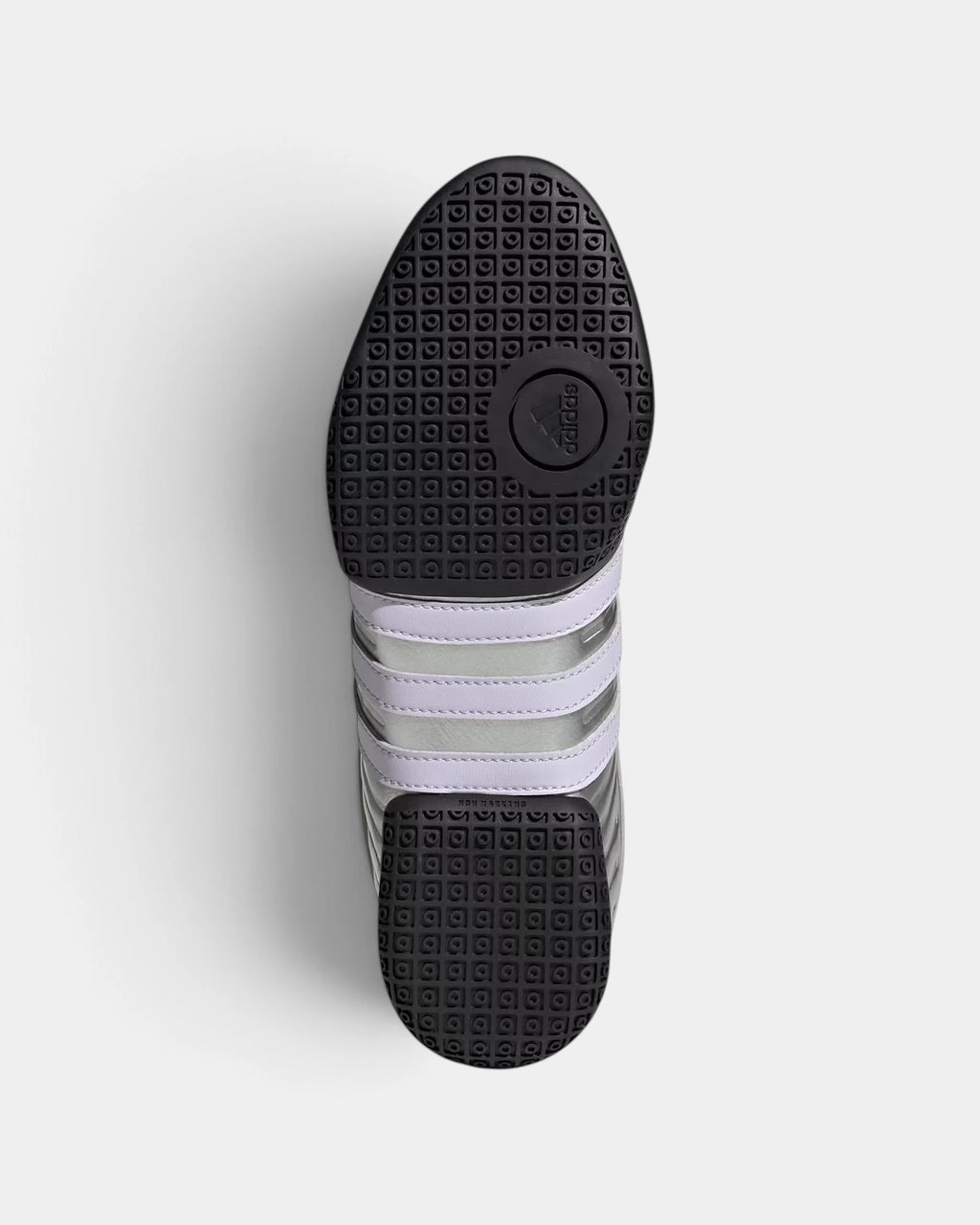 Lockwood Avenue adidas Taekwondo Mei Elite shoe turned over, showing the black pivot outsole with pale purple 3-Stripes across the midfoot