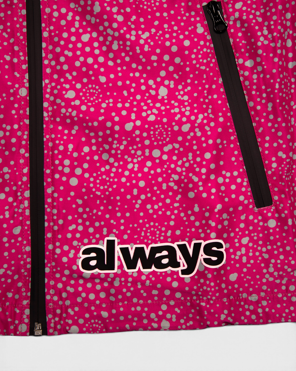 Lockwood Avenue ADWYSD Dotted Bandemic Jacket in Fuchsia, close-up of the always logo at the hem next to the black zip