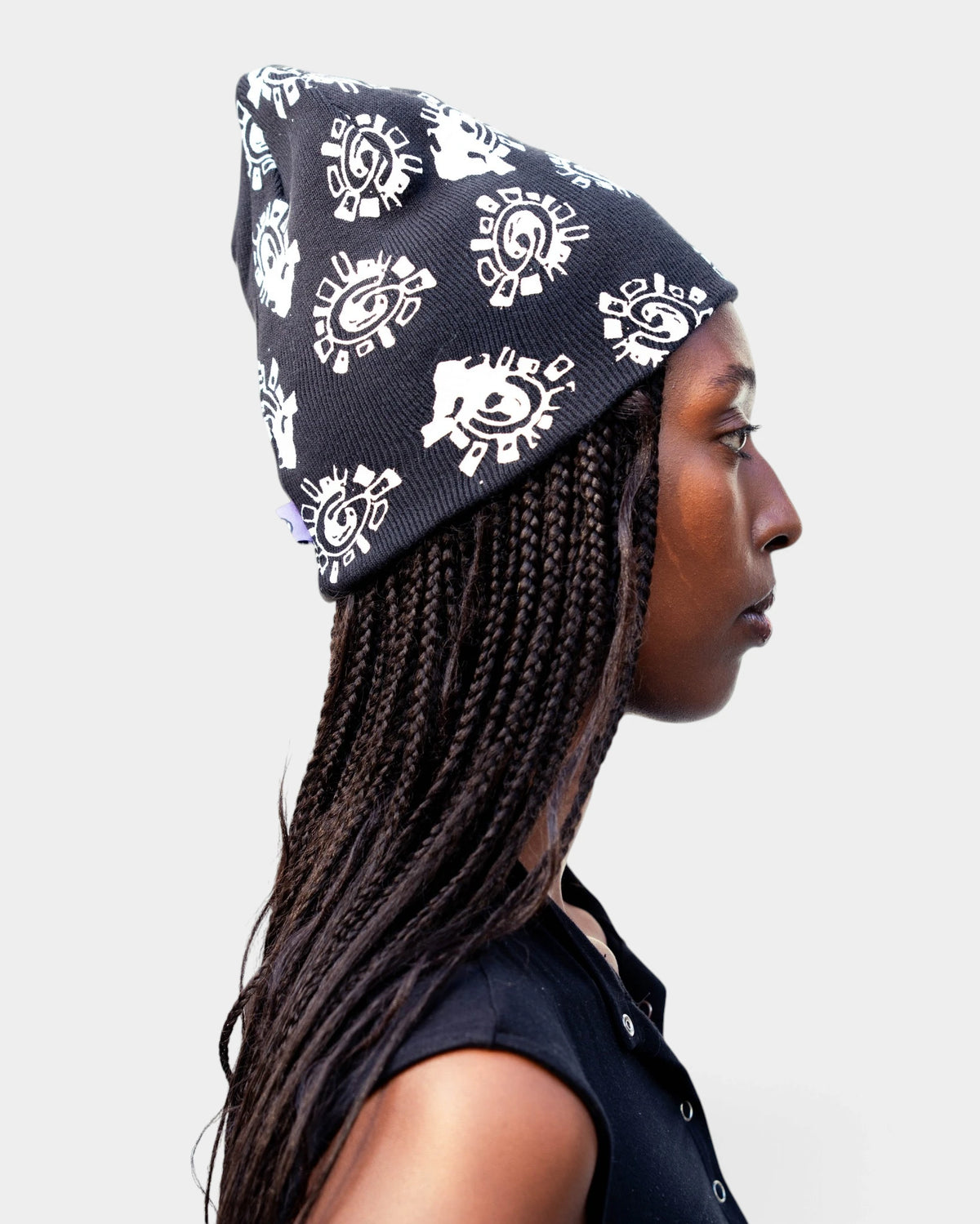 Lockwood Avenue ADWYSD Grunge @Sun All Over Print Beanie in Black, worn by a model in profile, white @ sun print all over