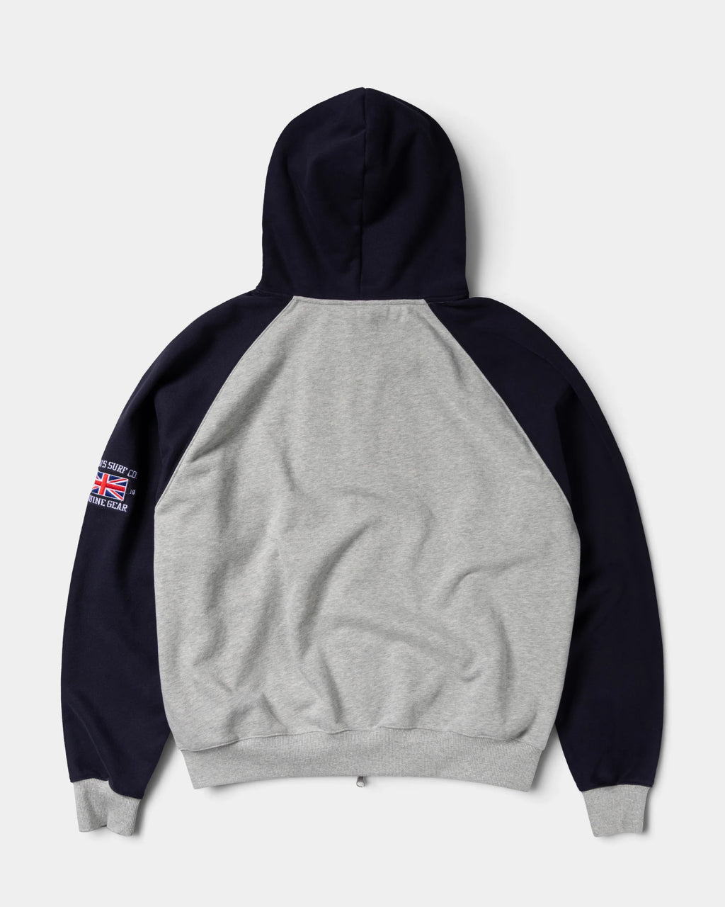 Lockwood Avenue ADWYSD Jersey Raglan Zip-Up Hoodie in Heather Grey seen from the back, navy hood and sleeves with a small Union Jack badge on the arm