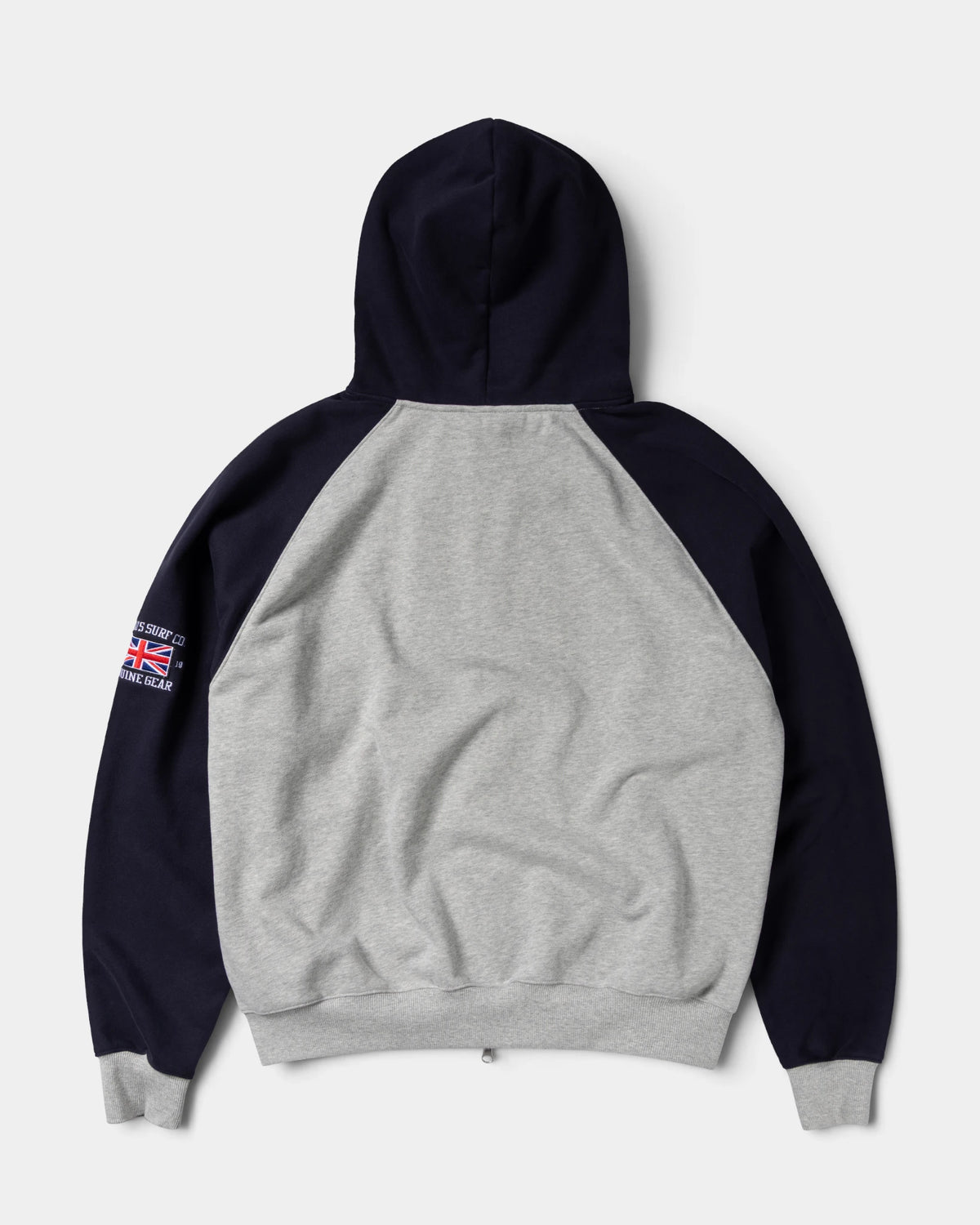 Lockwood Avenue ADWYSD Jersey Raglan Zip-Up Hoodie in Heather Grey seen from the back, navy hood and sleeves with a small Union Jack badge on the arm