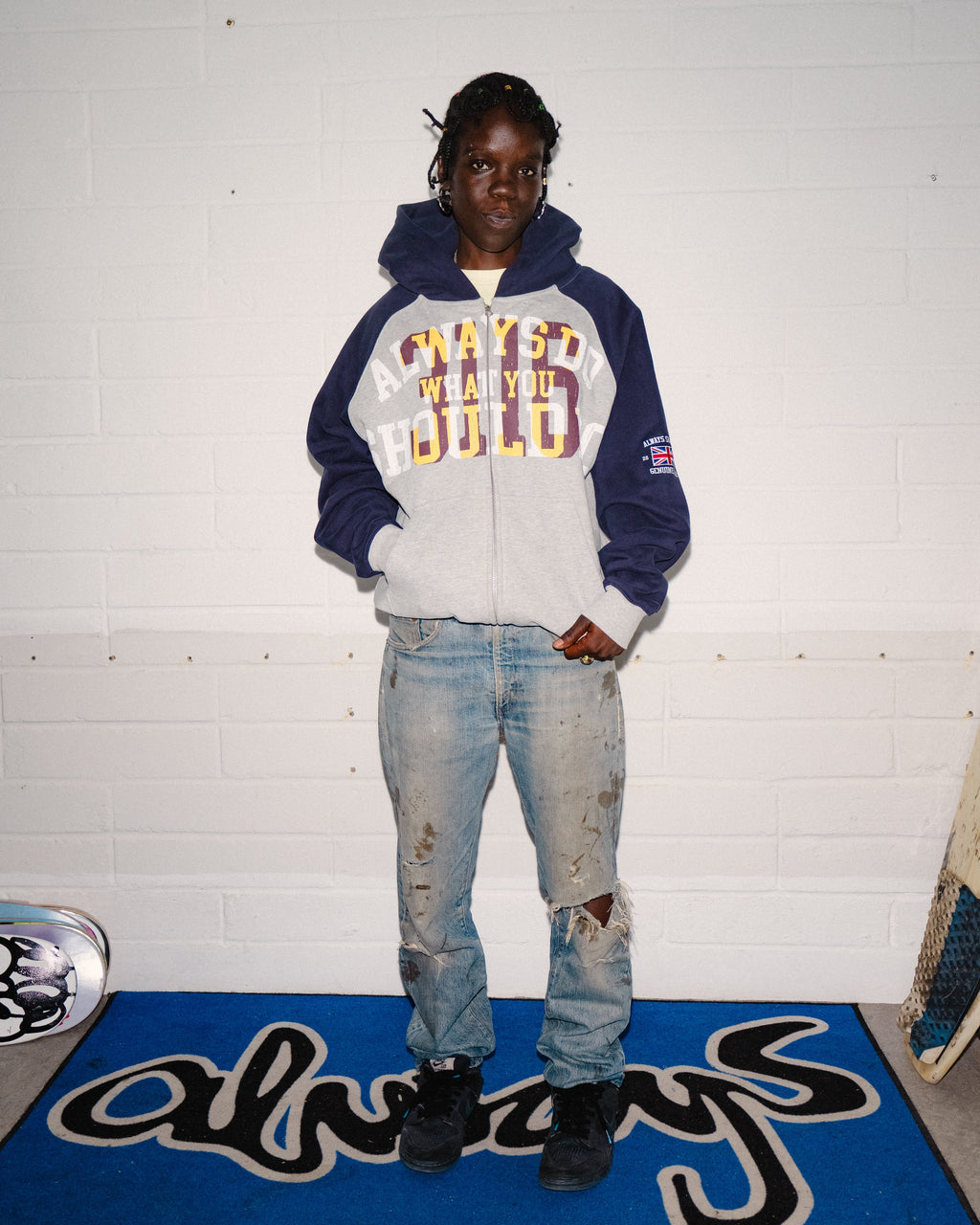 Lockwood Avenue ADWYSD Jersey Raglan Zip-Up Hoodie in Heather Grey worn zipped up by a model with ripped light wash jeans