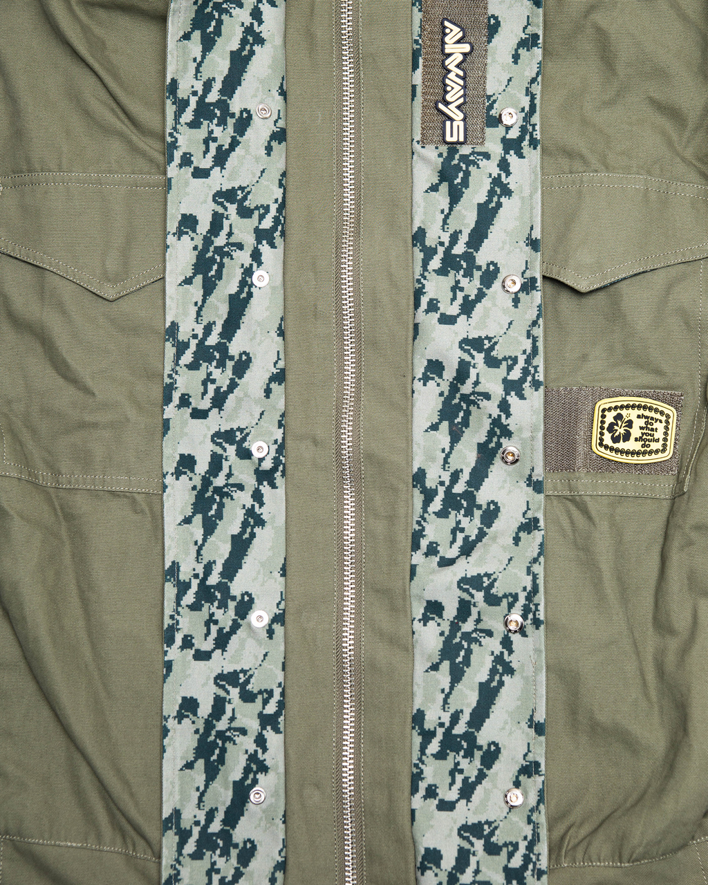 Lockwood Avenue ADWYSD NZ Digi Field Jacket in Green, close-up of the zip, camo placket and the woven patch on the chest pocket