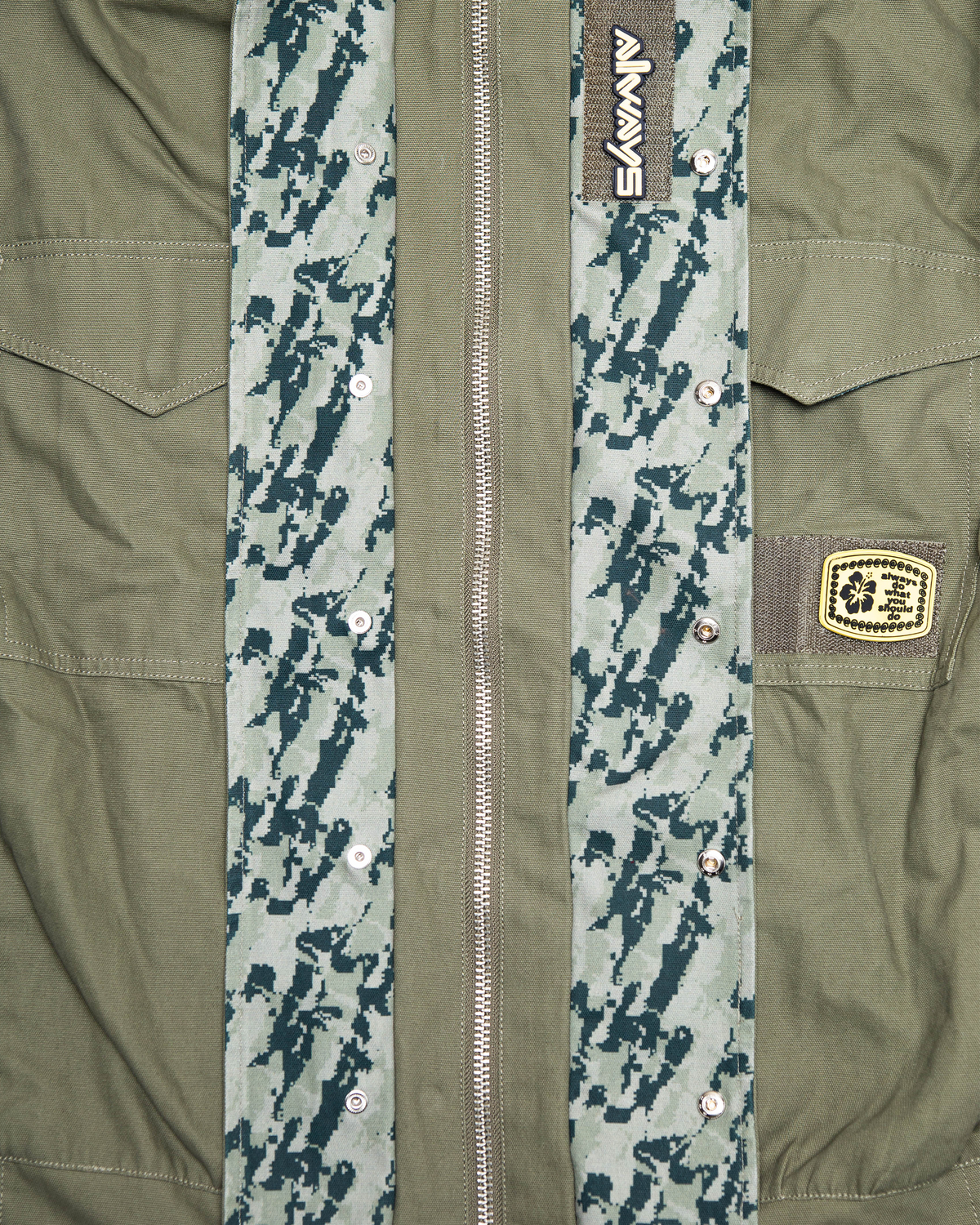 Lockwood Avenue ADWYSD NZ Digi Field Jacket in Green, close-up of the zip, camo placket and the woven patch on the chest pocket