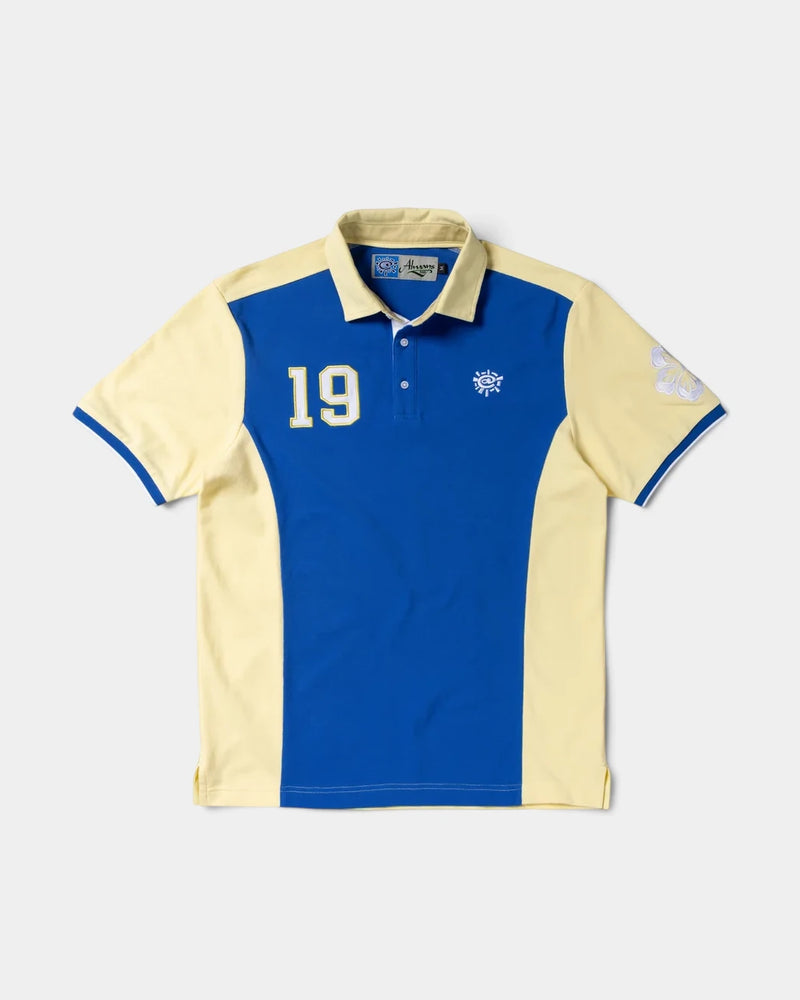 Lockwood Avenue ADWYSD Sport Polo in Yellow/Blue, front view with a royal blue front panel, pale yellow collar and sleeves, a number 19 patch and blue cuff trim