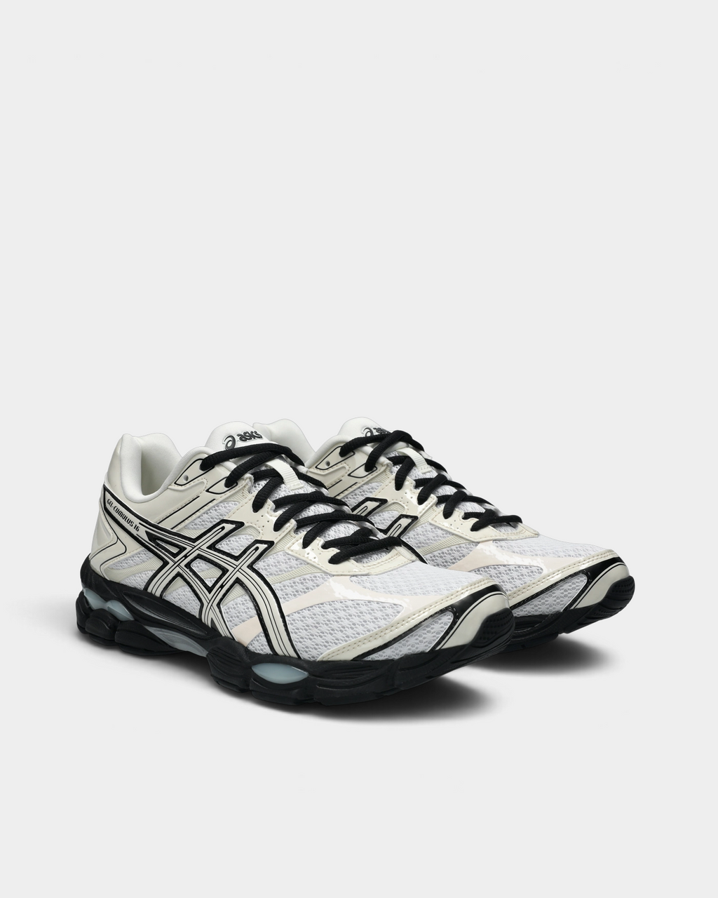 Asics GEL-Cumulus 16 Shoes in White/Cream, pair at a three-quarter front angle showing the white mesh toe box, black laces and the black sole