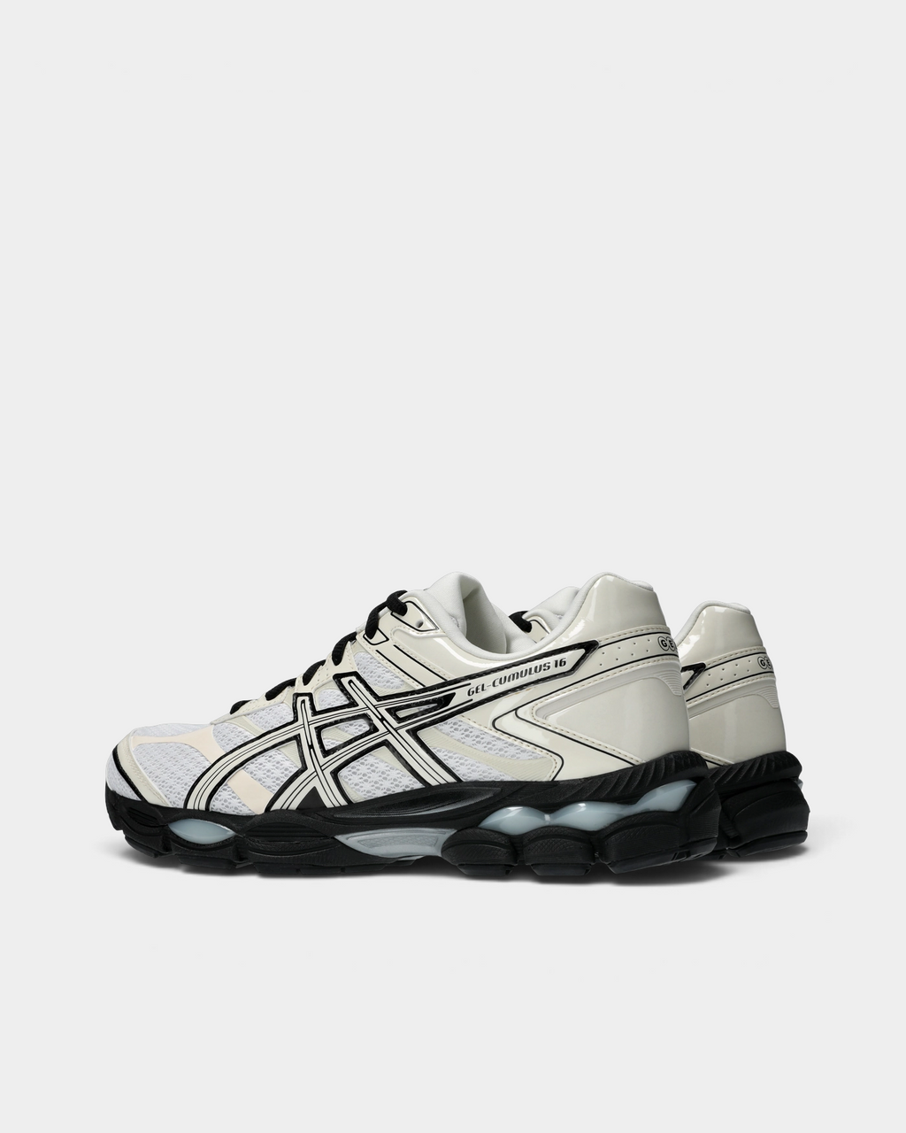 Asics GEL-Cumulus 16 Shoes in White/Cream, pair from the inner side: cream stripes outlined in black over white mesh, a glossy cream heel overlay and the black GEL midsole