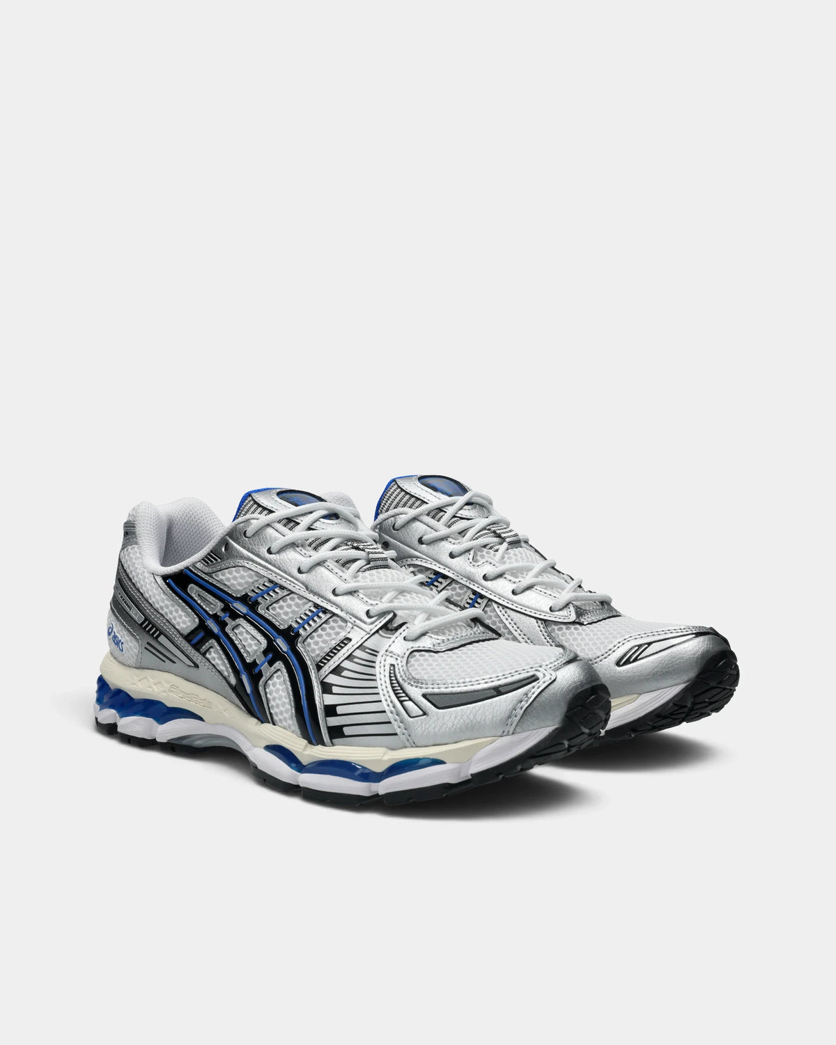 Asics GEL-Kayano 12.1 Shoes in White/Black, pair at a three-quarter front angle showing the silver toe overlays and black and blue ASICS stripes