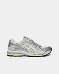 Asics GEL-Kayano 12.1 Shoes in White/Cream, side profile: white mesh under silver overlays, cream ASICS stripes and a cream midsole over a black outsole
