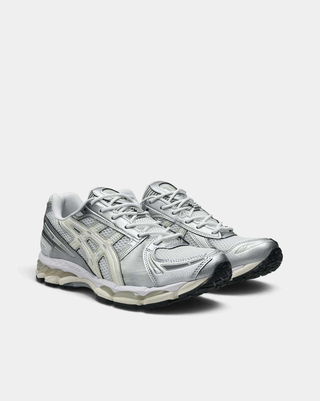 Asics GEL-Kayano 12.1 Shoes in White/Cream, pair at a three-quarter front angle showing the silver toe overlays and cream ASICS stripes