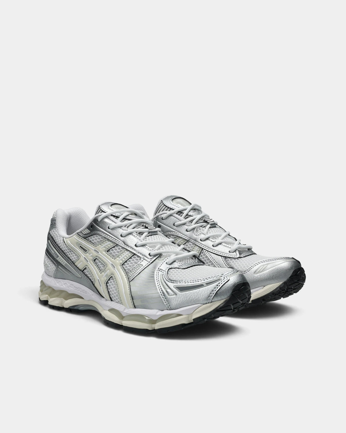 Asics GEL-Kayano 12.1 Shoes in White/Cream, pair at a three-quarter front angle showing the silver toe overlays and cream ASICS stripes