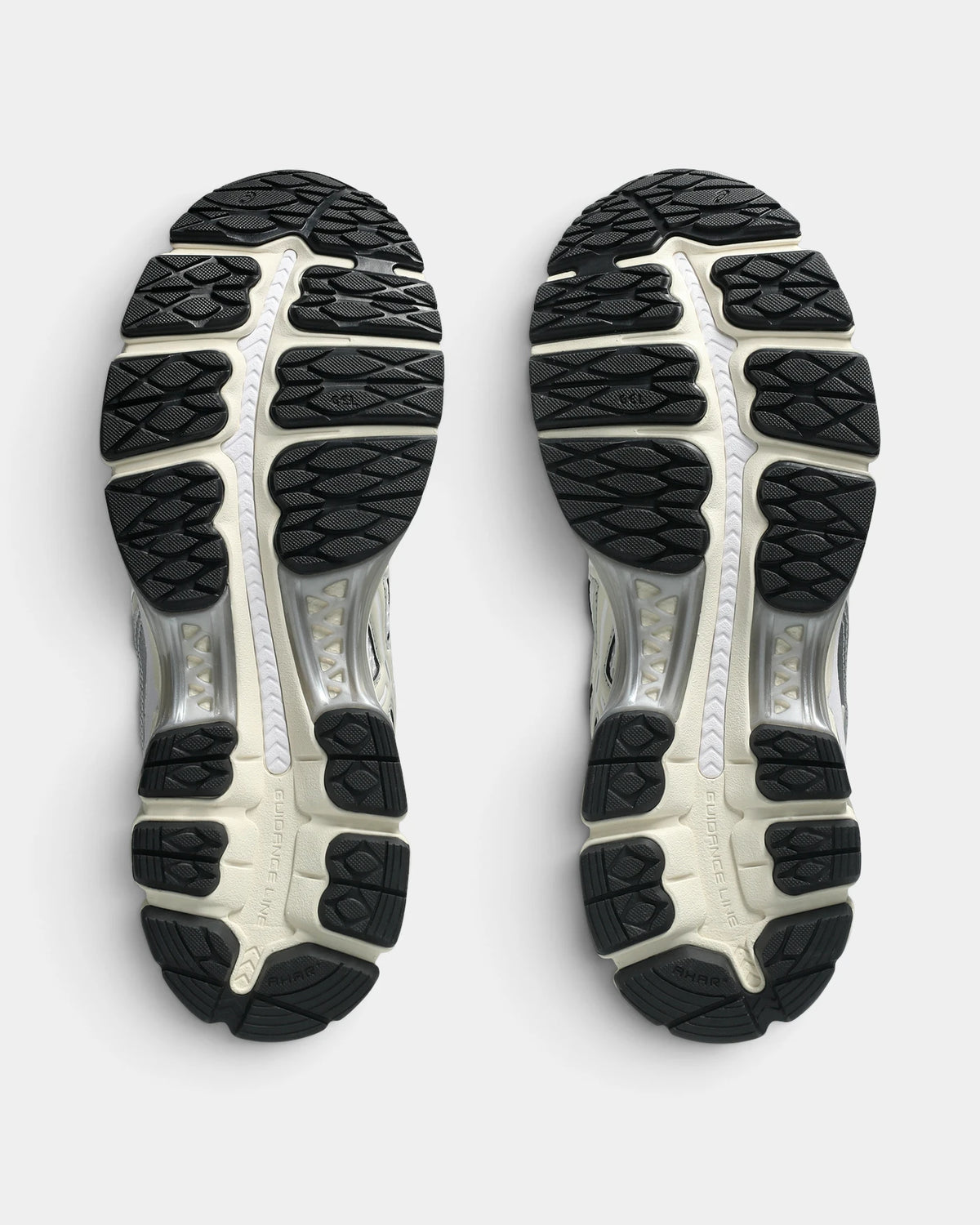 Asics GEL-Kayano 12.1 Shoes in White/Cream, outsoles of the pair: black rubber lugs around a silver and cream midfoot