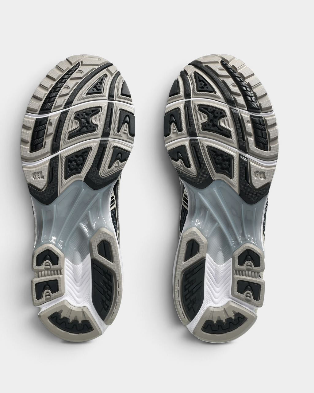 Asics GEL-Kayano 14 Shoes in Carrier Grey/Black, outsoles of the pair: black and gray rubber blocks with a silver-gray GEL window under the midfoot