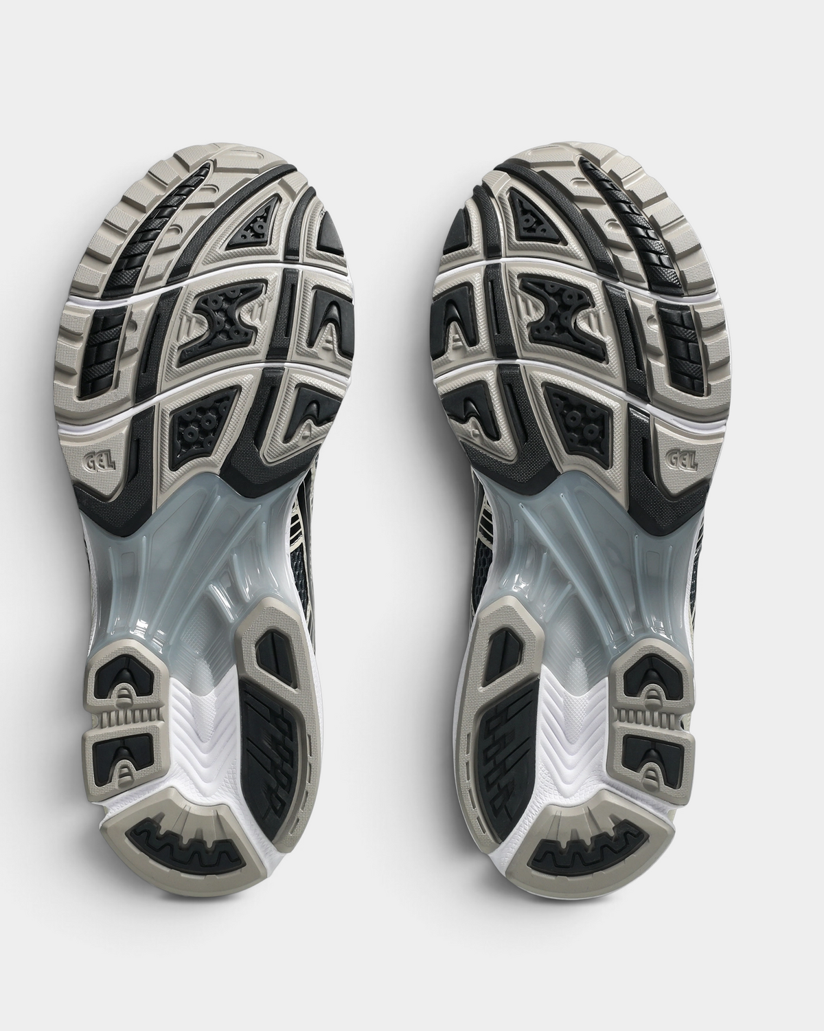 Asics GEL-Kayano 14 Shoes in Carrier Grey/Black, outsoles of the pair: black and gray rubber blocks with a silver-gray GEL window under the midfoot