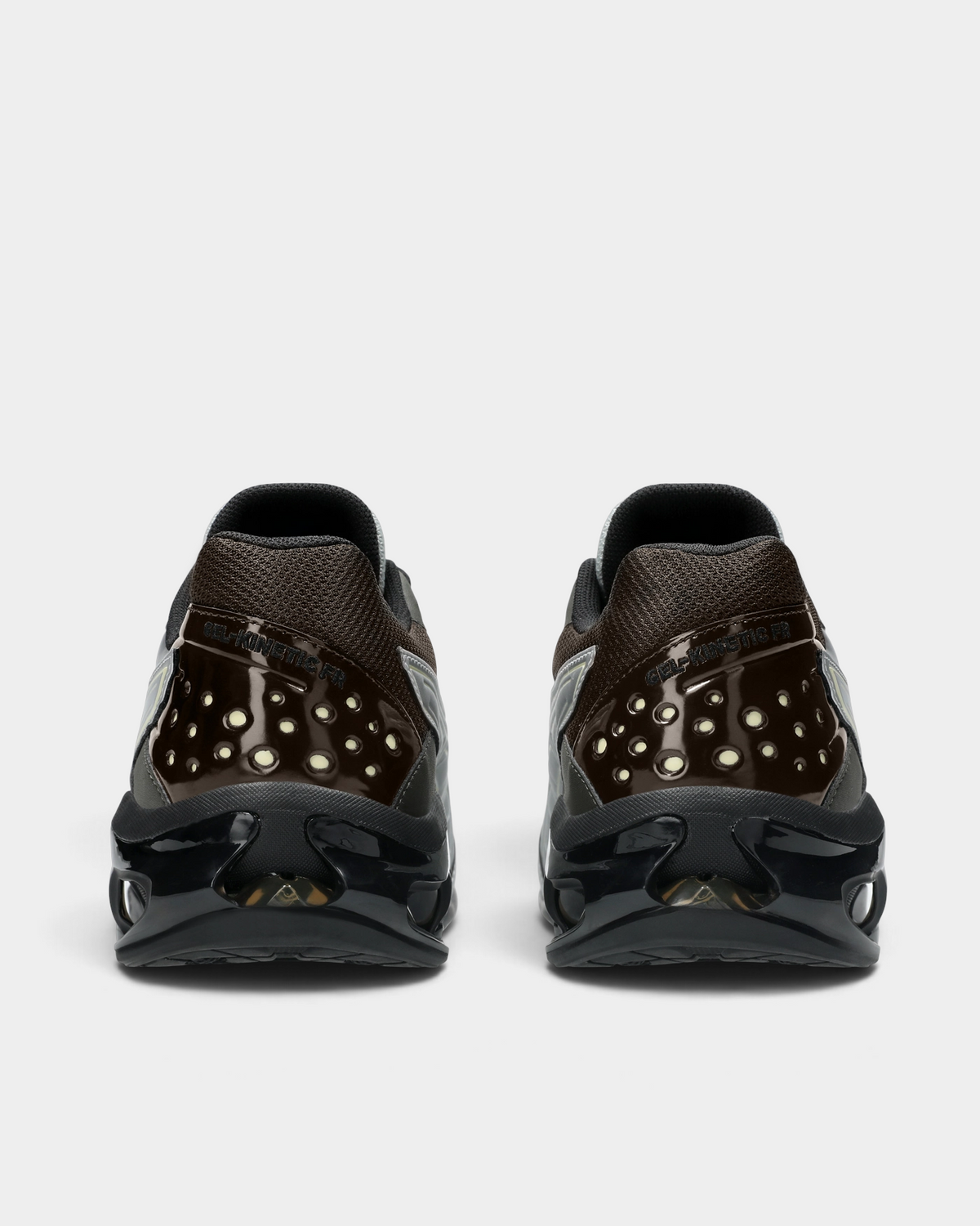 Asics GEL-Kinetic FR Shoes in Pure Silver/Black Coffee, pair from behind: glossy dark brown heel panels with perforations over a black sole with open GEL windows