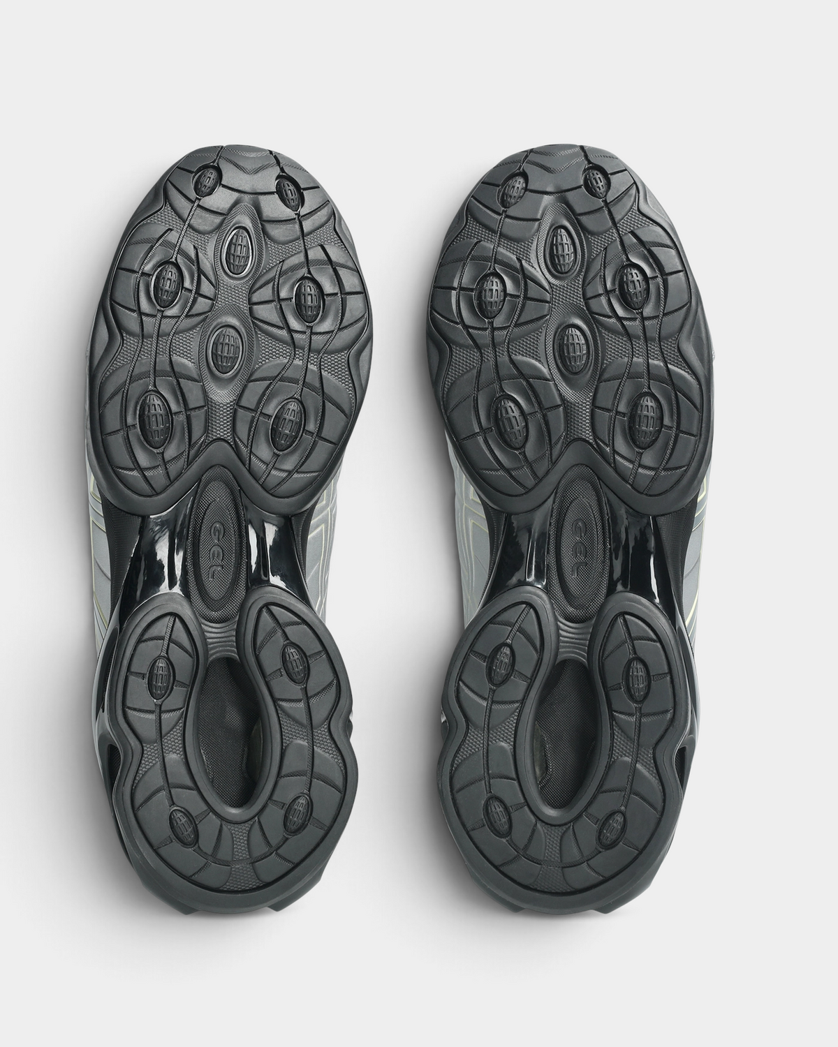 Asics GEL-Kinetic FR Shoes in Pure Silver/Black Coffee, outsoles of the pair: dark gray rubber with raised round pads under the GEL pods