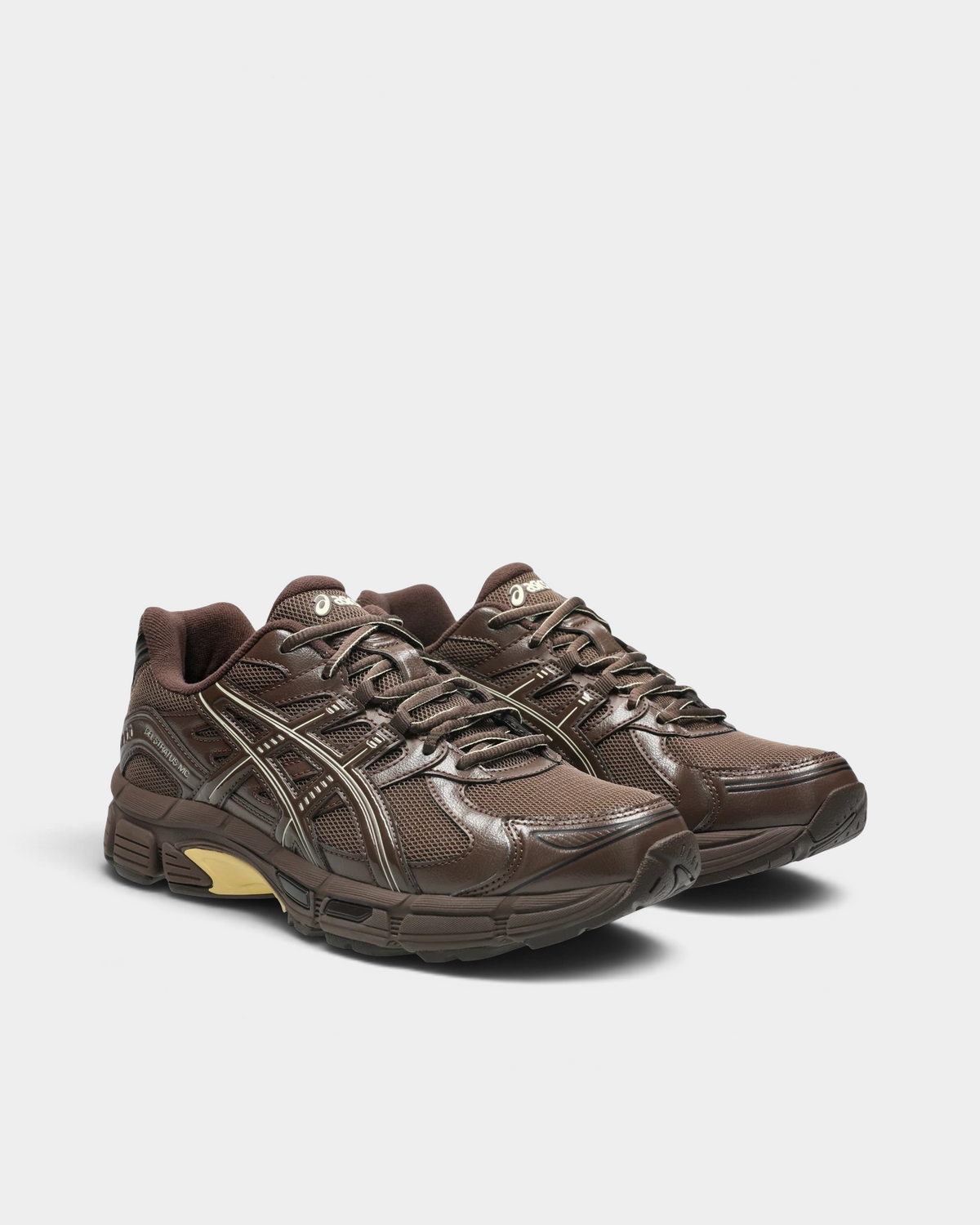 Asics GEL-Stratus MC Shoes in Brown Storm, pair at a three-quarter front angle showing brown laces, the cream ASICS stripes and the lighter ASICS logo on the tongue