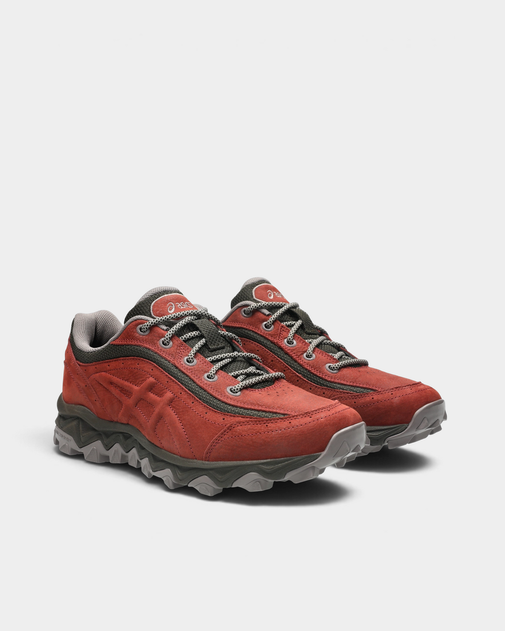 Asics GEL-Transcend FJ Shoes in Rusted Rock/Black Coffee, pair at a three-quarter front angle showing the rust-red toe box, gray laces and the lugged sole