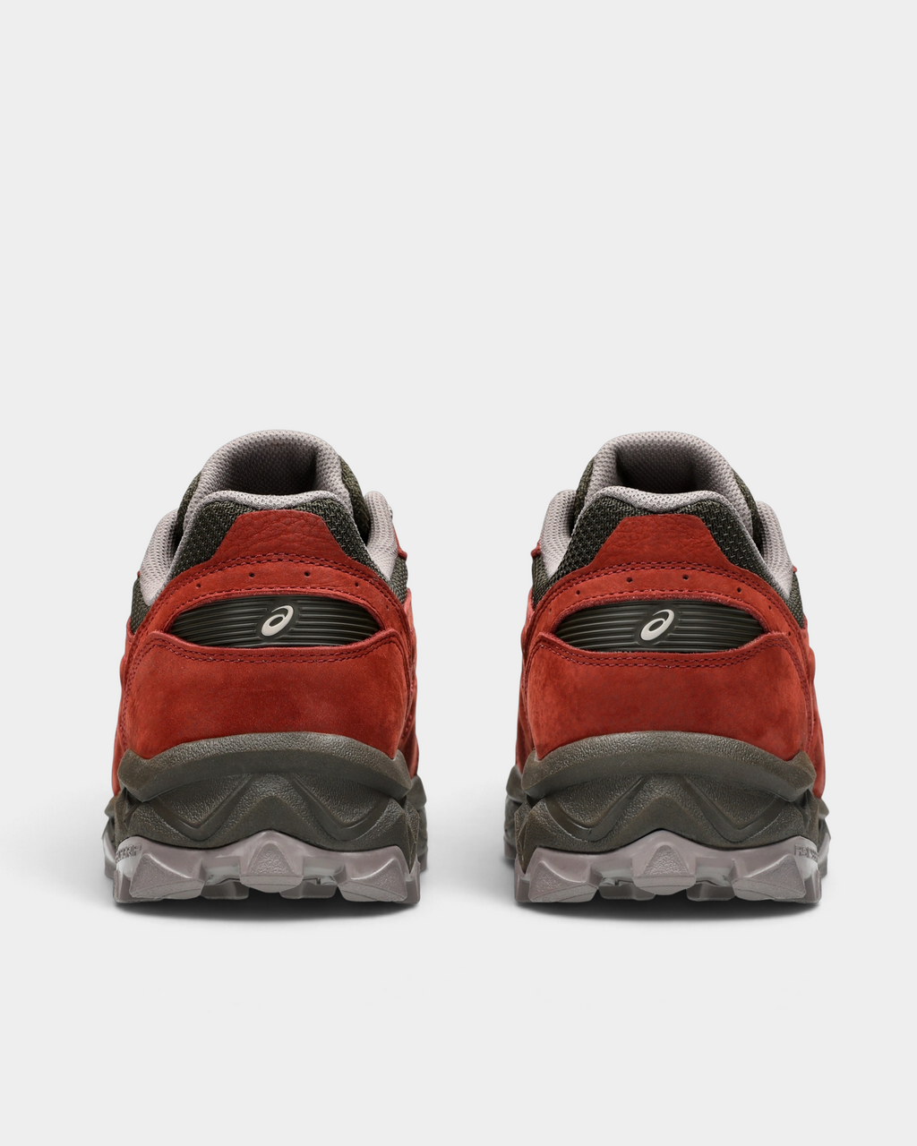 Asics GEL-Transcend FJ Shoes in Rusted Rock/Black Coffee, pair from behind: rust-red heels with dark brown collars over the lugged sole
