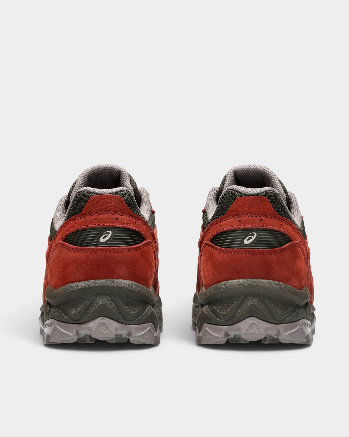 Asics GEL-Transcend FJ Shoes in Rusted Rock/Black Coffee, pair from behind: rust-red heels with dark brown collars over the lugged sole